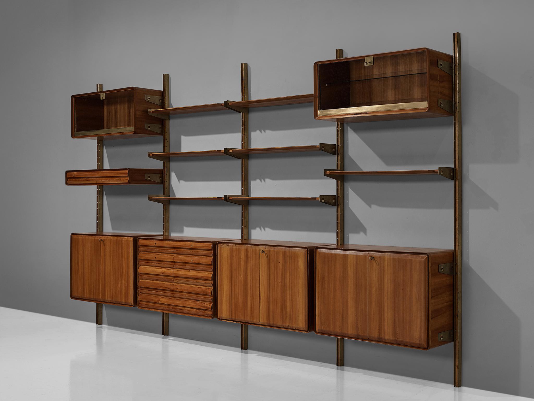 Cabinet, wood, glass and metal, Italy, 1960s.

The monumental wall-mounted cabinet consists of four wall sections with various different storage facilities. The shelves and compartments are mounted on steel profiles. The storage facilities exist