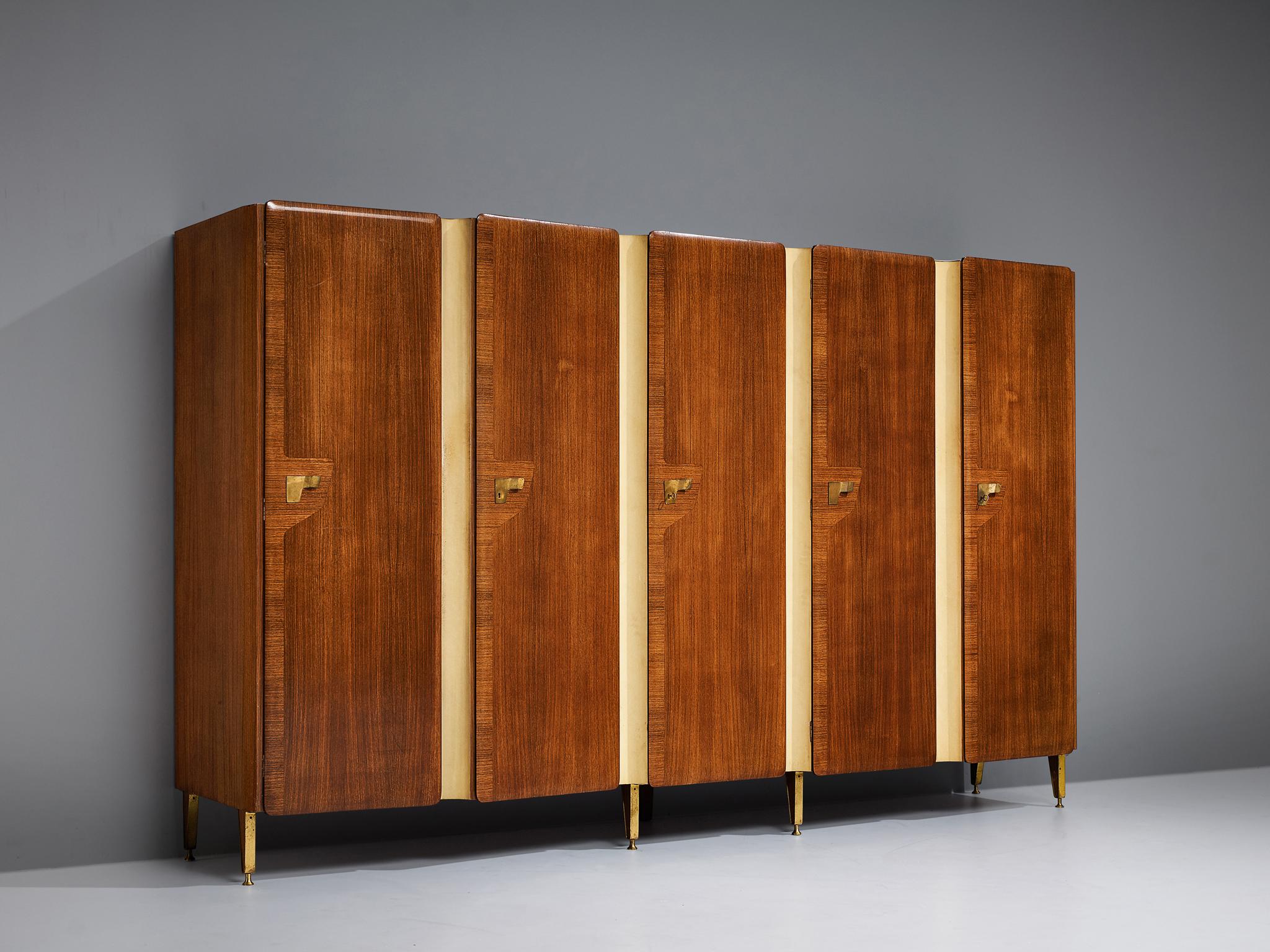 Large Italian wardrobe, walnut, synthetic material, brass, Italy, 1950s

With the combination of bright stripes in vertical direction alternating with the dark walnut doors with golden colored brass handels gives this wardrobe a strong visual
