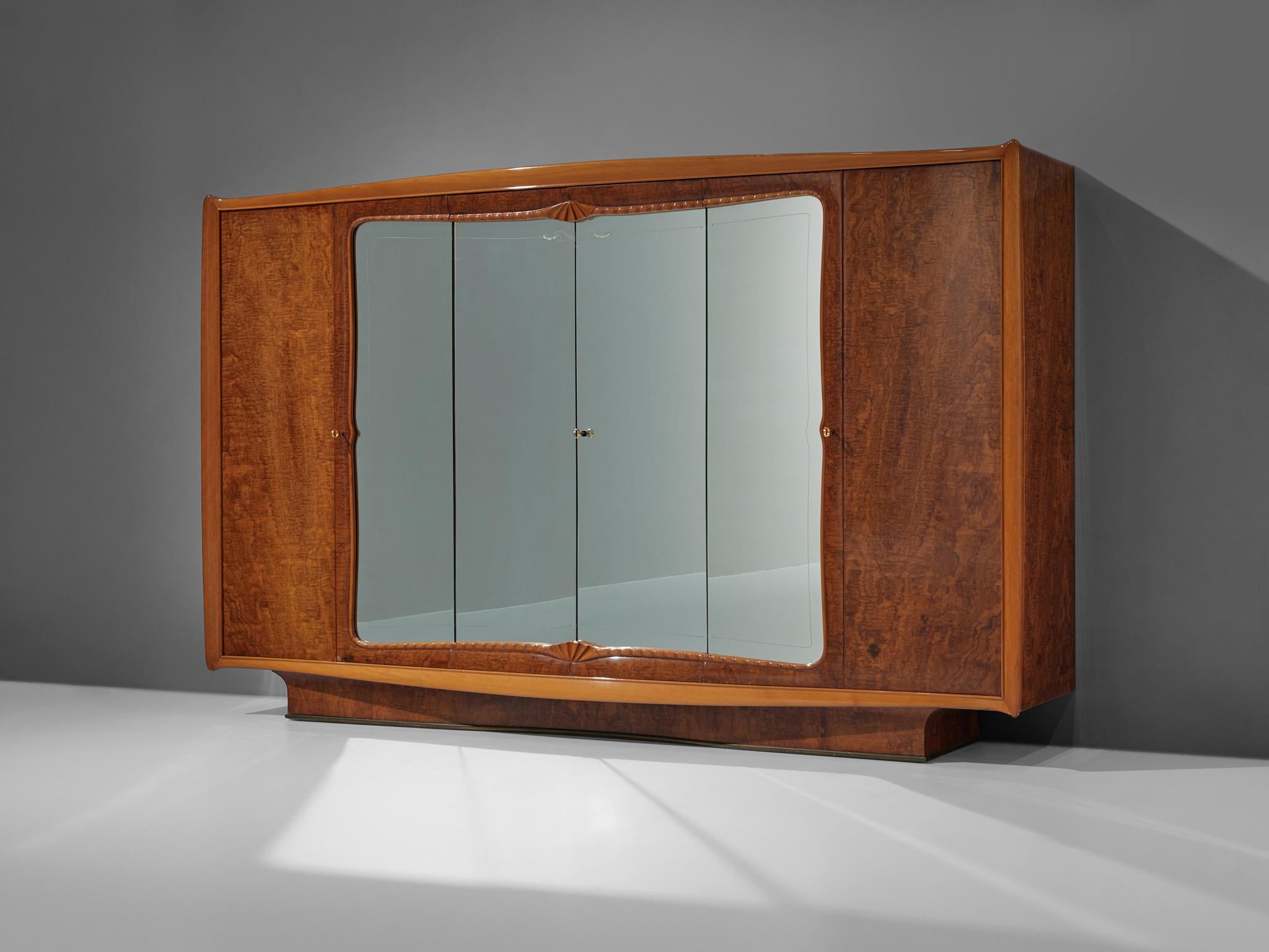 Large Italian wardrobe, walnut burl, glass, brass, mahogany, maple, Italy, 1950s

This exclusive Italian wardrobe has a remarkable size; with its width of over 10ft, this cabinet offers plenty of storage space. Four doors hold a mirrored surface