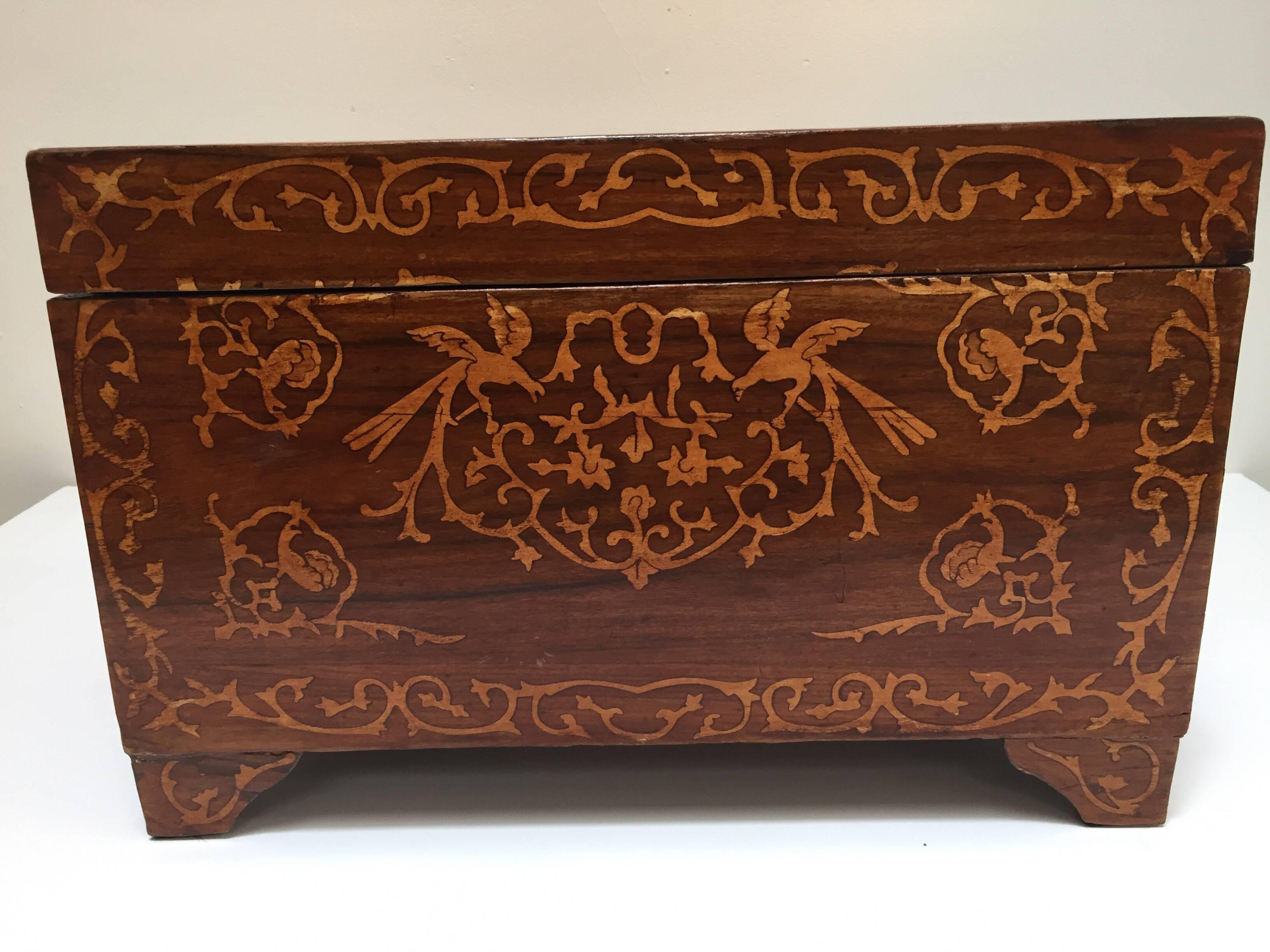 Large Italian box inlaid with precious fruitwood on a rich warm reddish brown wood.
Large wedding chest inlaid with light precious fruitwood of elaborate birds, foliate and floral on all four sides.
Very decorative, large desirable collector piece