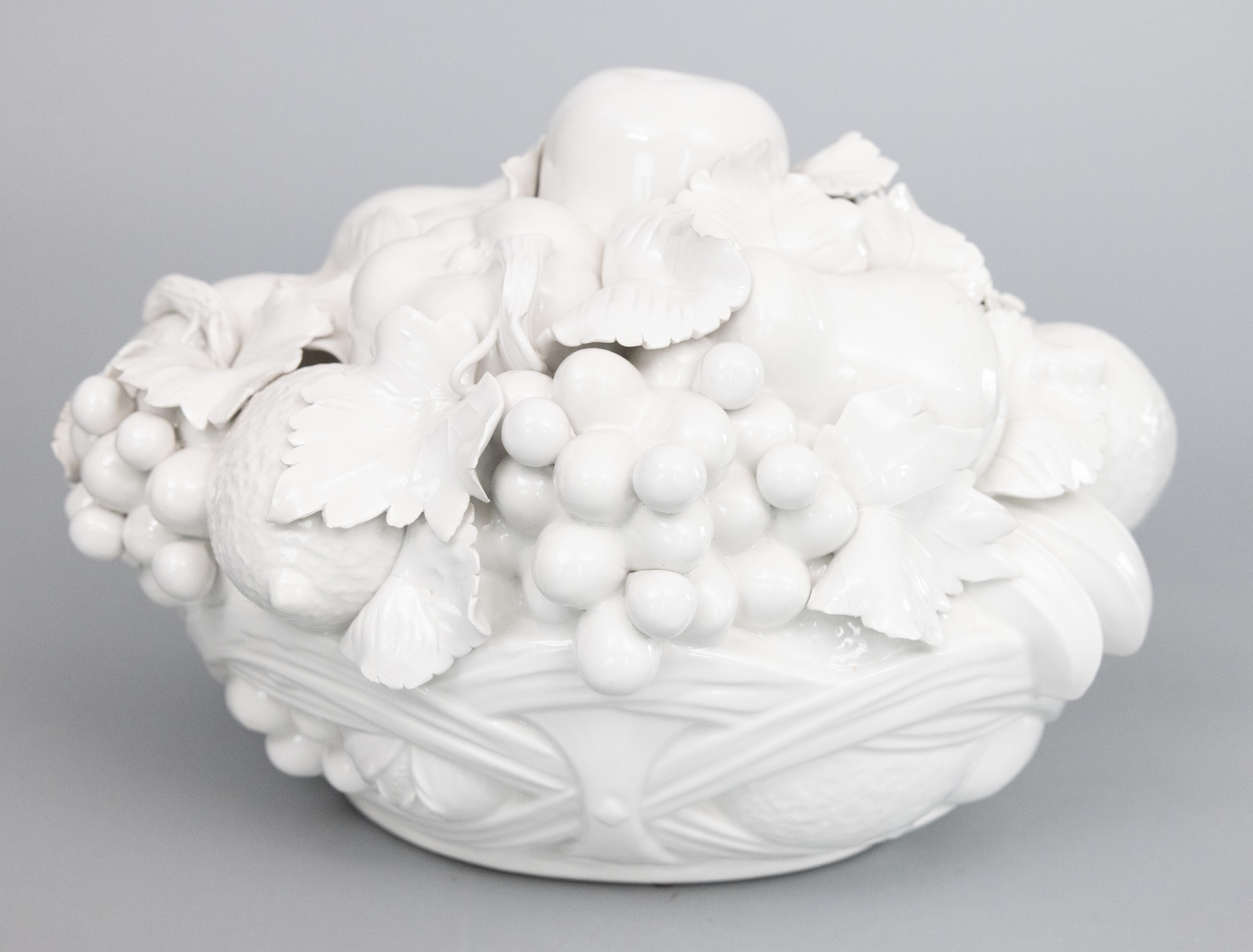 A stunning large Mid-Century Italian Blanc de Chine creamware glazed ceramic handmade fruit bowl or basket centerpiece. No maker's mark. This gorgeous arrangement features a hand molded assortment of fruit and leaves with exquisite details. Add