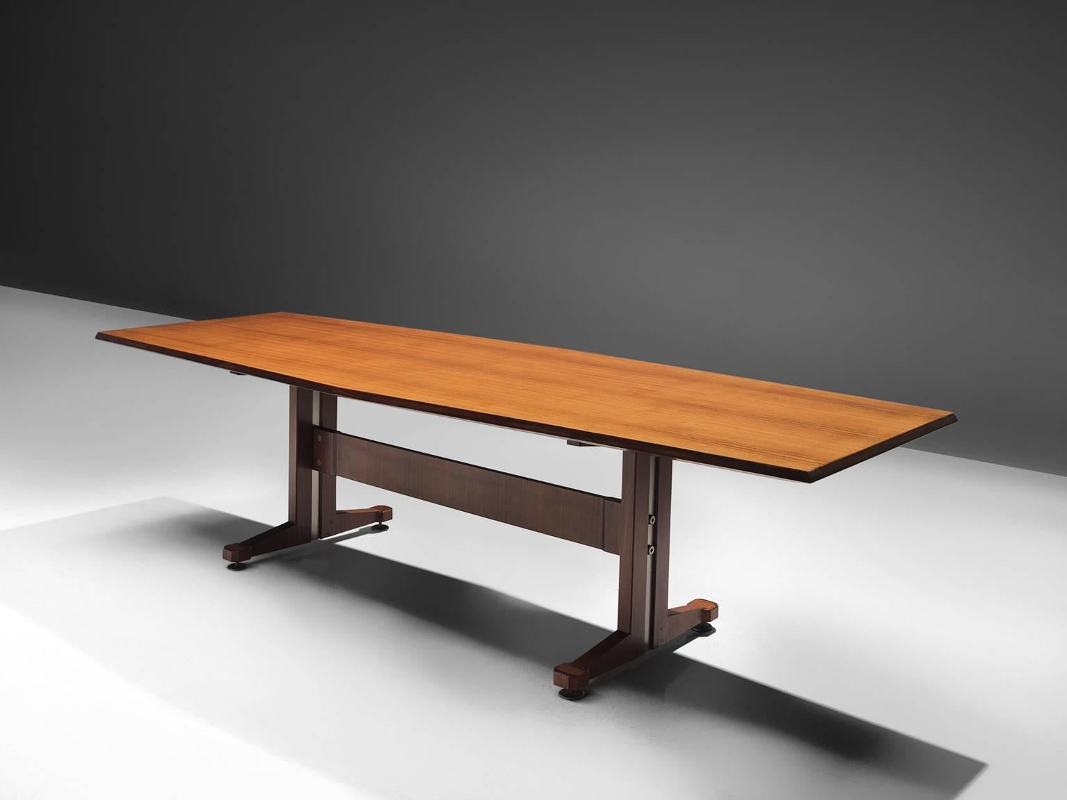 Conference table, rosewood, Italy, circa 1950

This conference table features two legs and a connecting beam. This table is features traits of the design of Borsani and Sallochi. The table's top shows beautiful grains and the frame features a