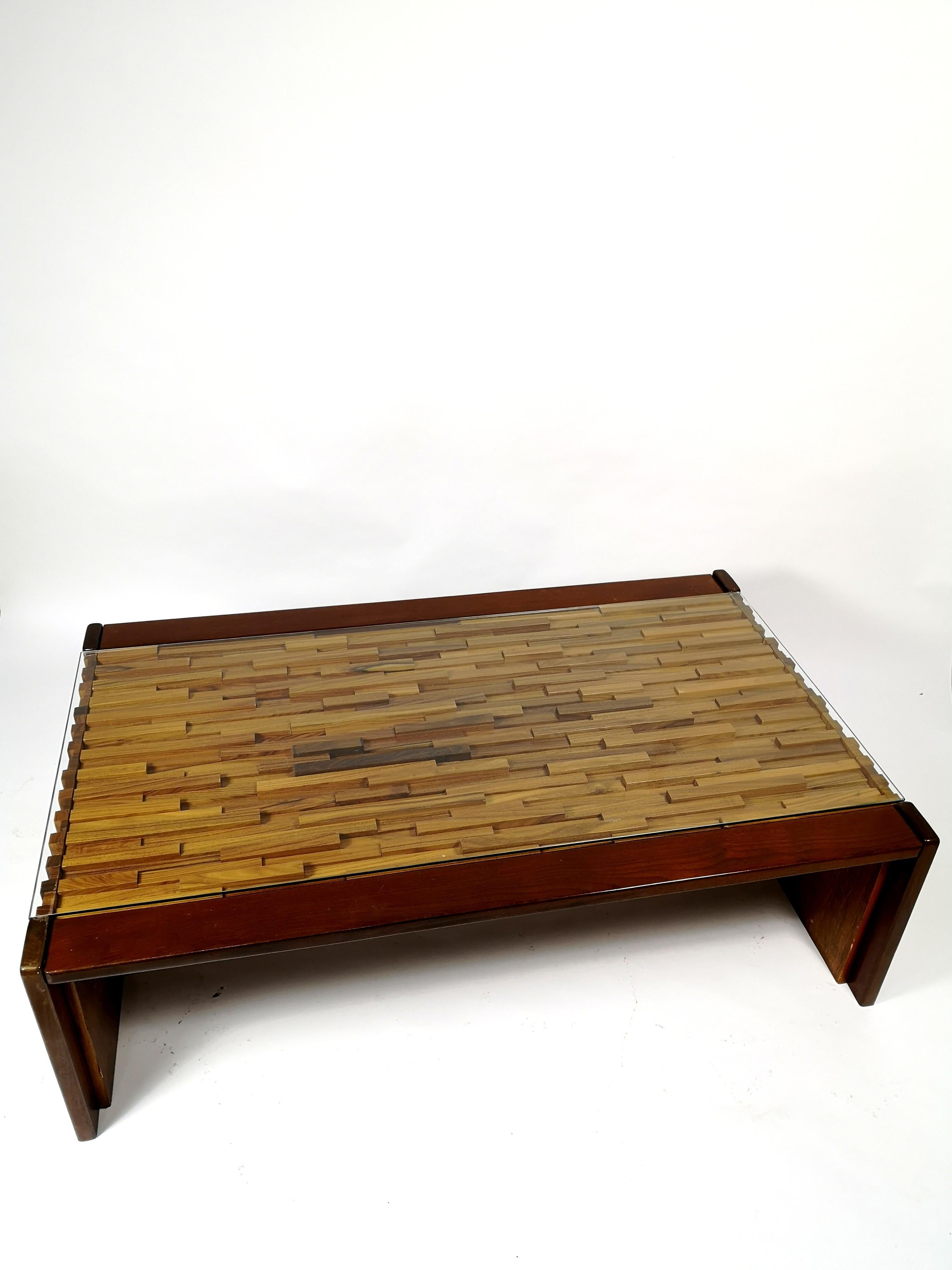 Designed by Percival Lafer, this table is marked and manufactured in Brazil during the 1960s. The table made of rosewood, teak, and jacaranda. It has a thick glass top the table is in original condition, with some minor surface damage, otherwise