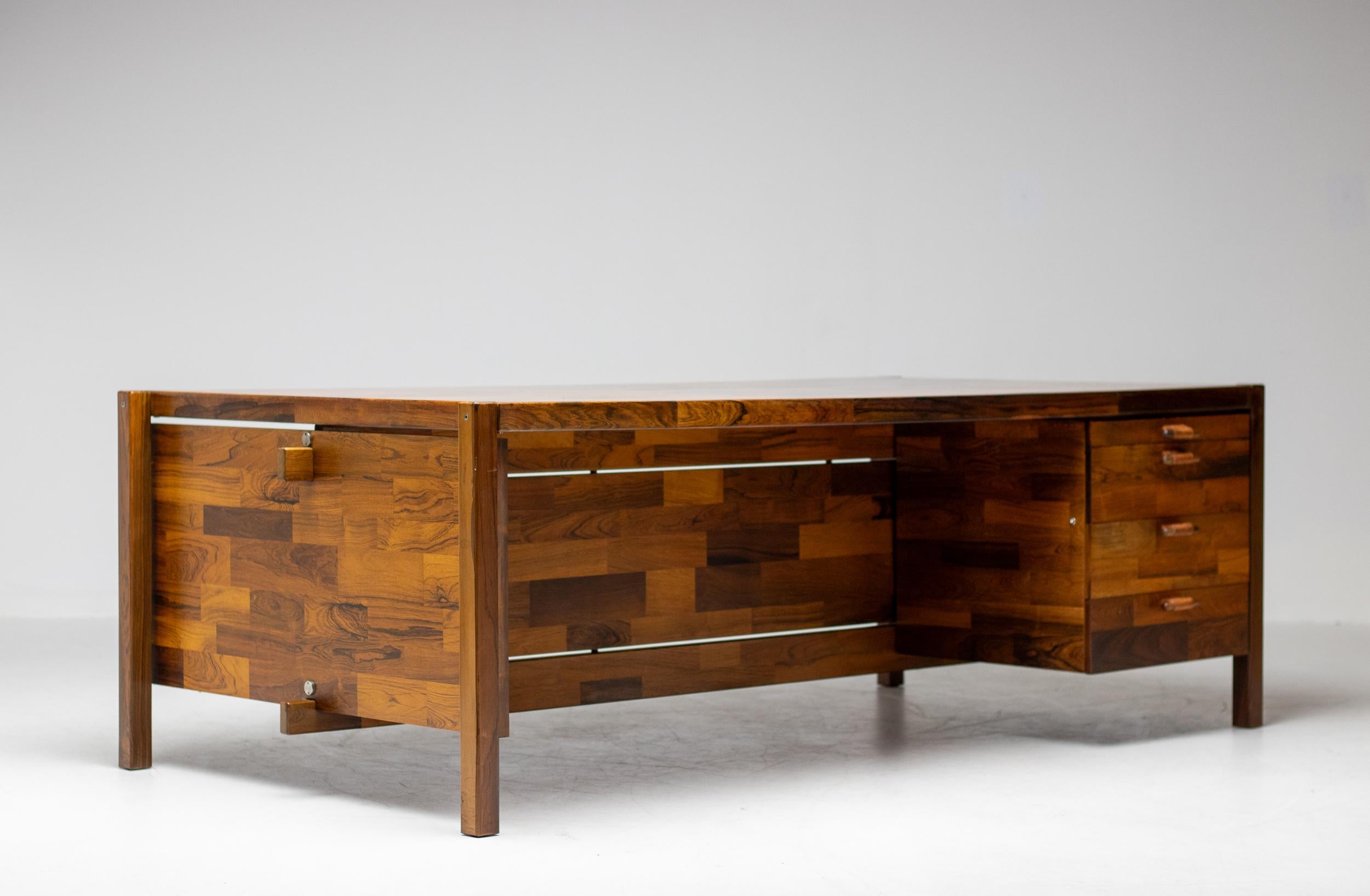 Beautiful large desk designed by Jorge Zalszupin, manufactured by L’Atelier San Paulo, circa 1960. 
Made of high quality jacaranda wood. The desk has four drawers with very well crafted grips made of jacaranda wood and natural leather. In good