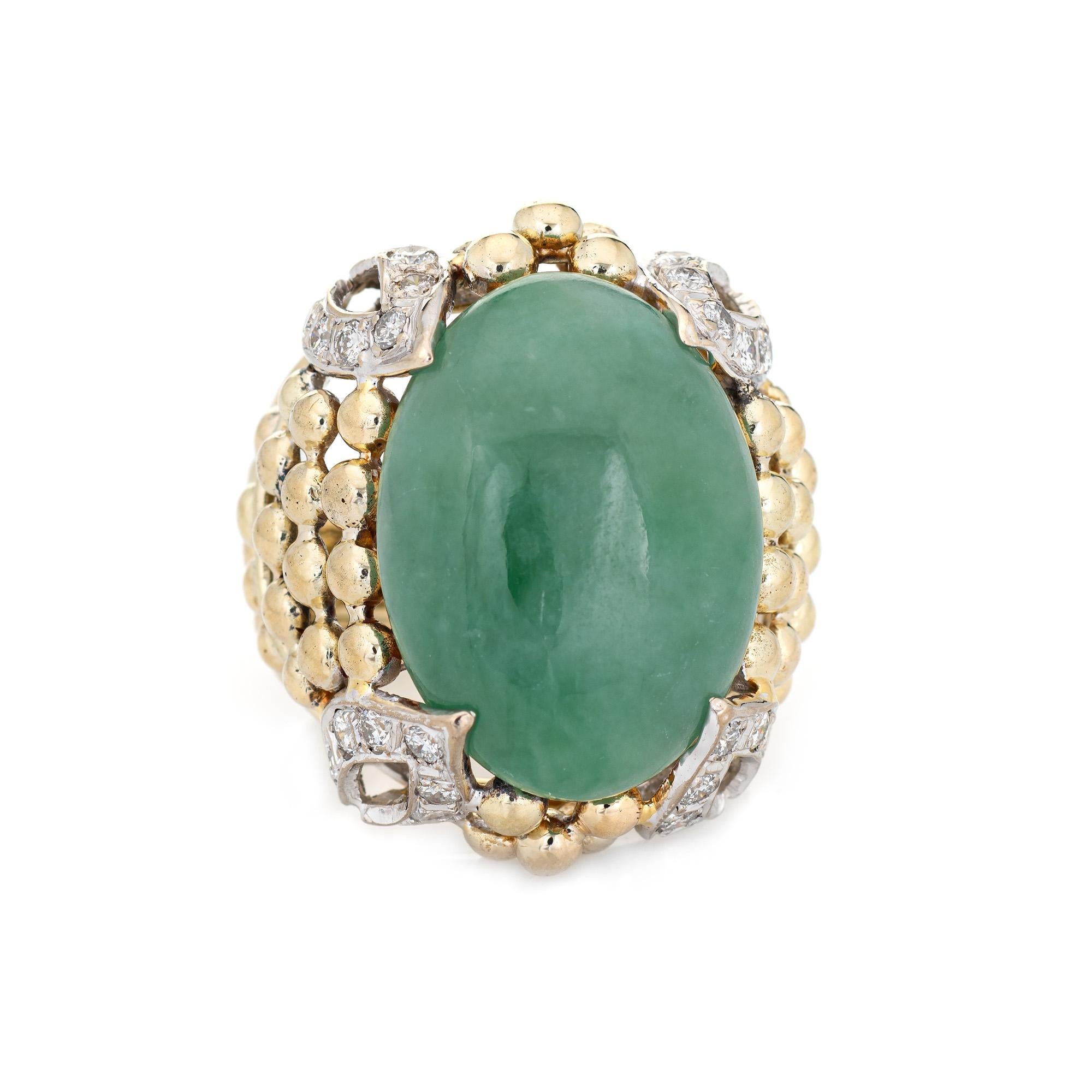 Stylish vintage jade & diamond cocktail ring (circa 1960s) crafted in 18 karat yellow gold. 

Cabochon cut jade measures 22mm x 16mm (estimated at 14 carats). The jade is in very good condition and free of cracks or chips. 28 diamonds total an