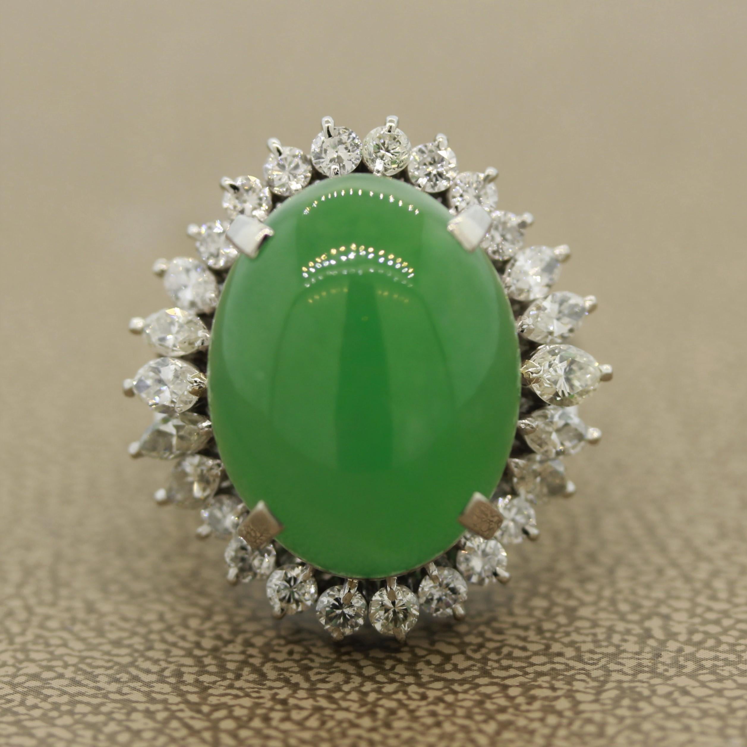 A fabulously large and impressive jadeite jade ring set in platinum. The jade weighs 18.30 carats and has a pleasing green color that seems to glow in the light. It is accented by 1.65 carats of large marquise and round brilliant cut diamonds. A