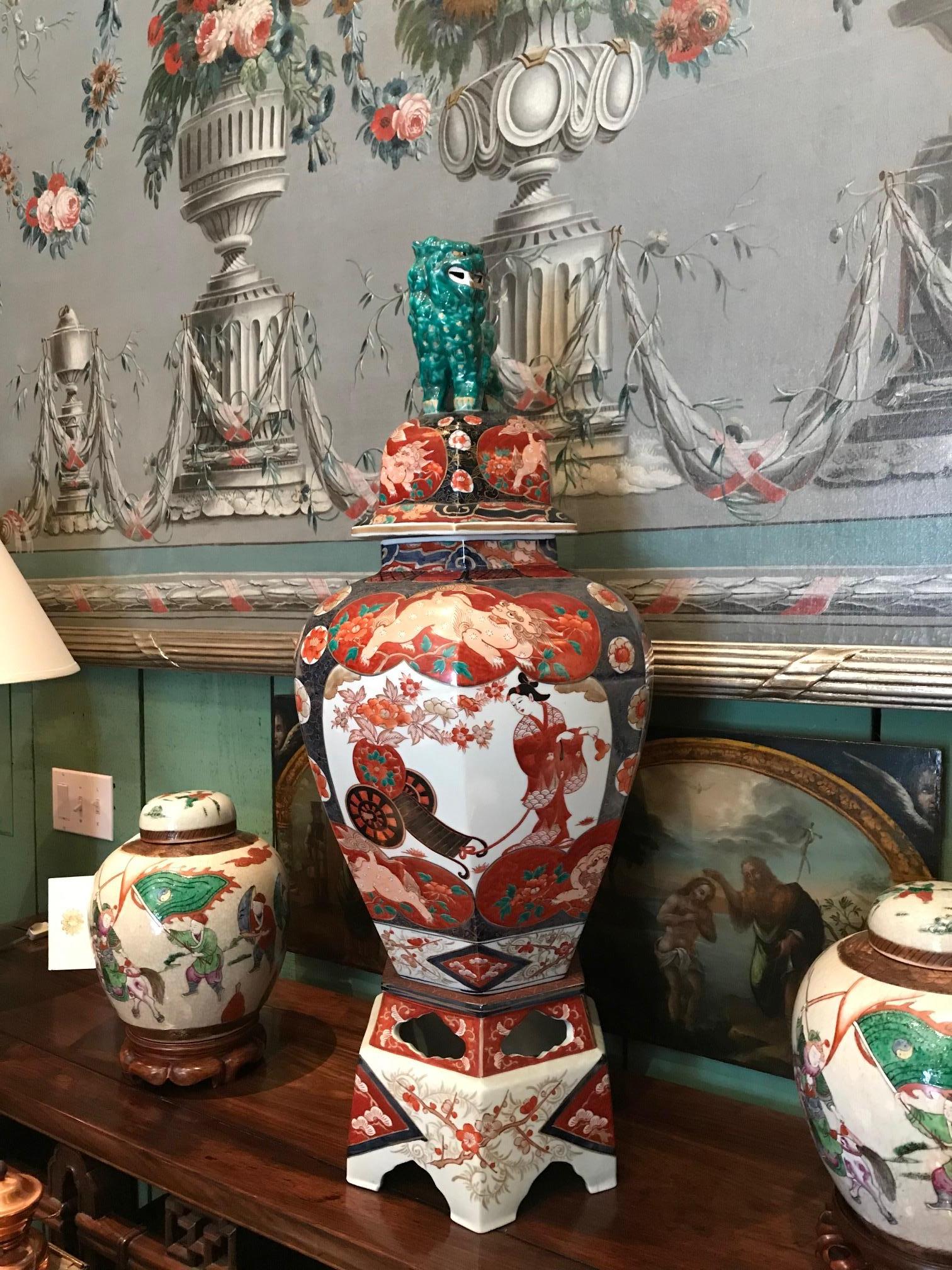 A large and impressive pair of 19th century Japanese Imari Baluster lidded vase with cover, having Foo dogs on the lid, intricately hand painted floral panels pattern and surrounds of wisteria and chrysanthemums. Antique dealer Los Angeles Beverly