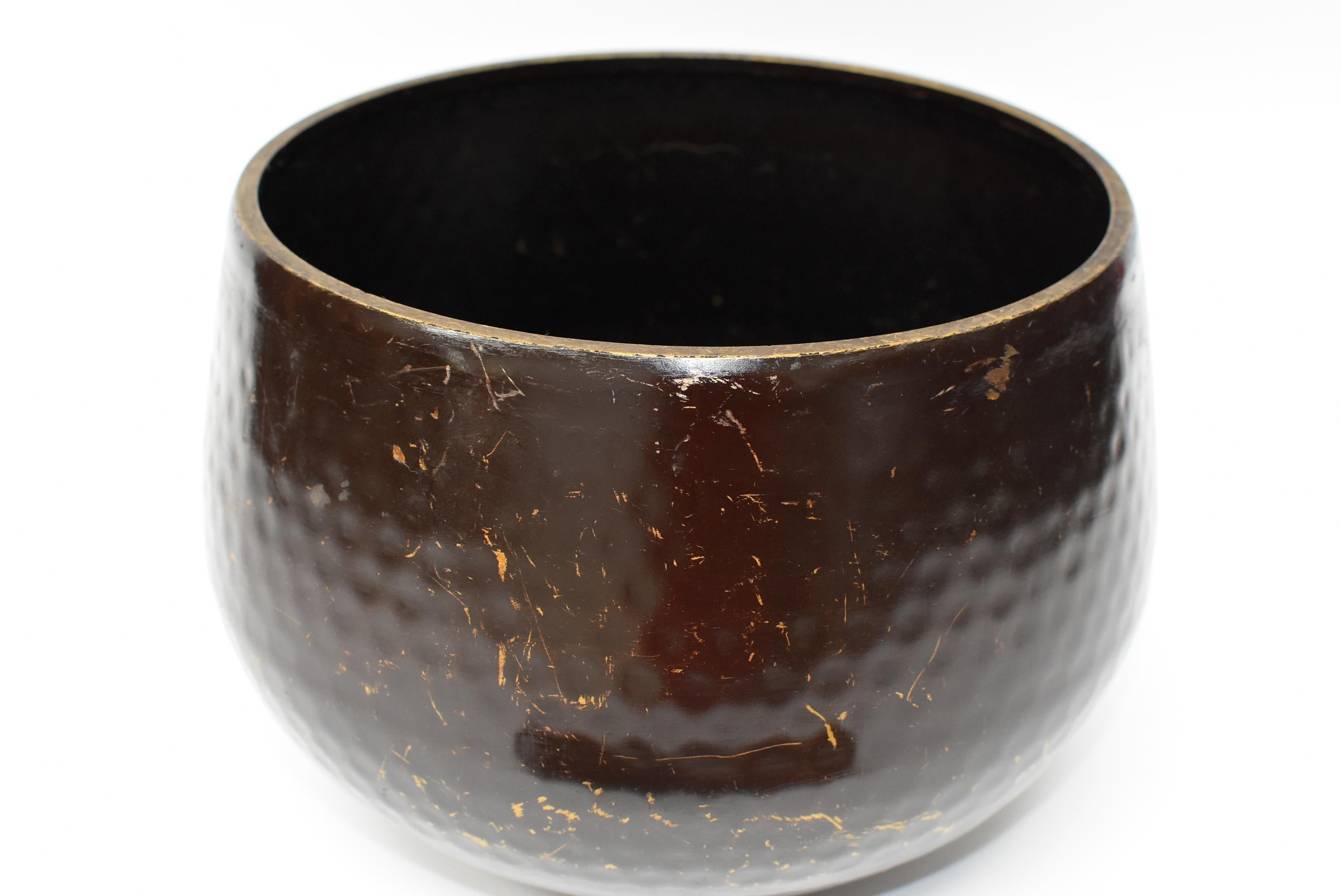 This is a large, substantial, handmade, antique Japanese singing bowl with a brown finish. The material is solid bronze. Beautiful dimpled texture in beehive pattern is hand-hammered. All patina is original. This bowl makes the most beautiful,