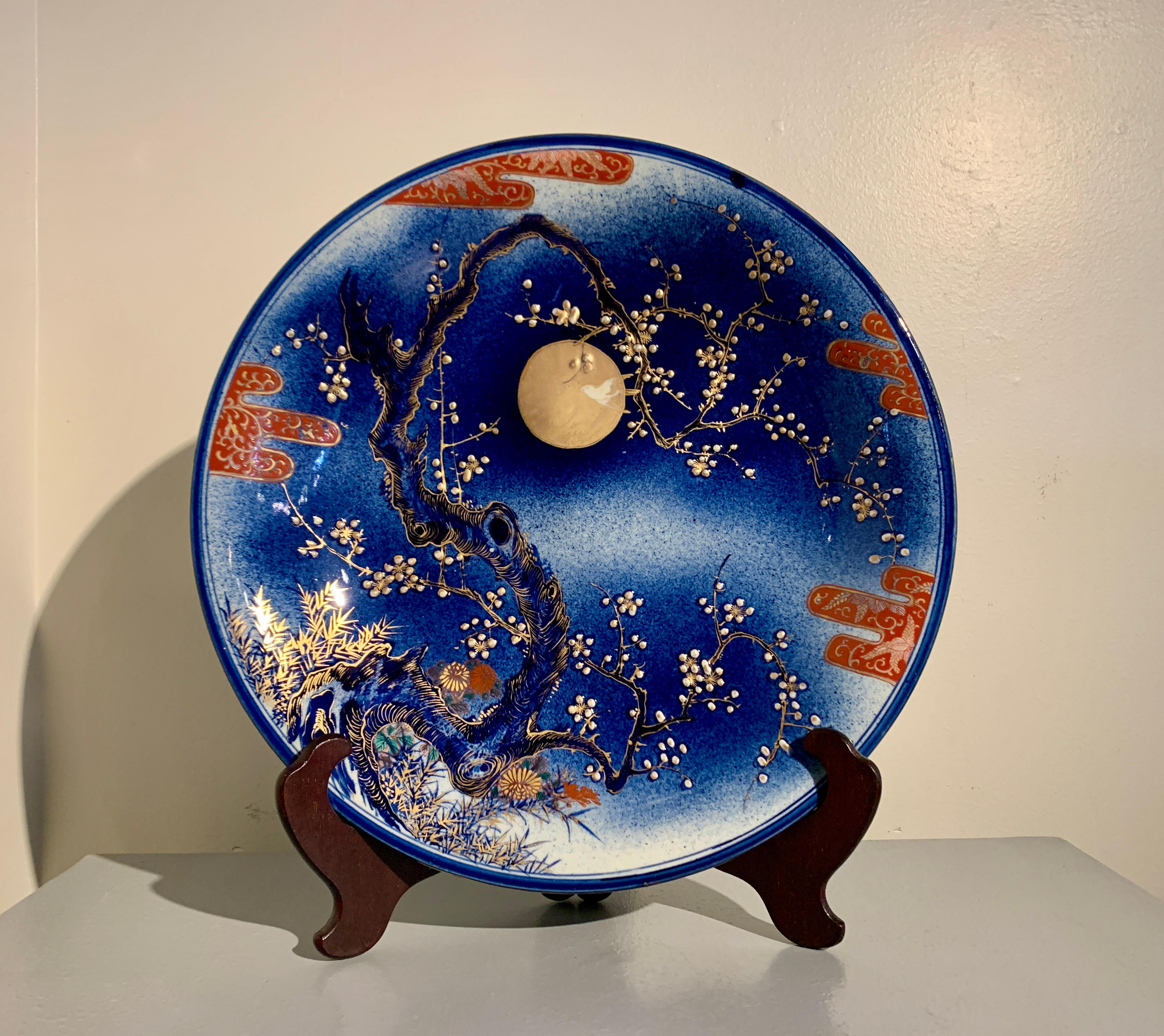 A large and boldly decorated Japanese Art Nouveau underglaze blue Imari porcelain charger with gilt and raised design, Taisho Period, circa 1915, Japan.

The charger features a fantastic design in the Art Nouveau style of a large plum tree with