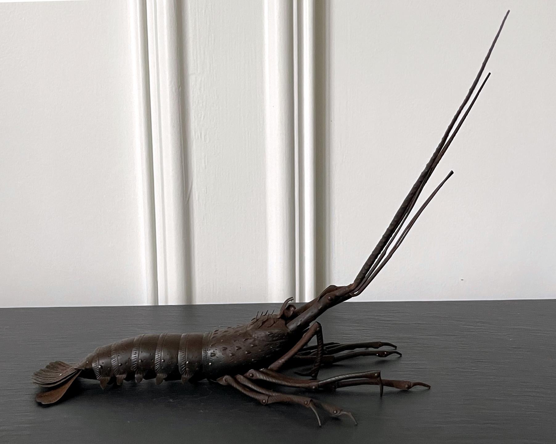 A large articulate spiny lobster (Ise-Ebi) as an ornamental display item, known in Japanese as Jizai Okimono, was made by Myochin Muneyuki circa 1940-50s. The lobster was meticulously constructed in life-size with patinated iron in a realistic