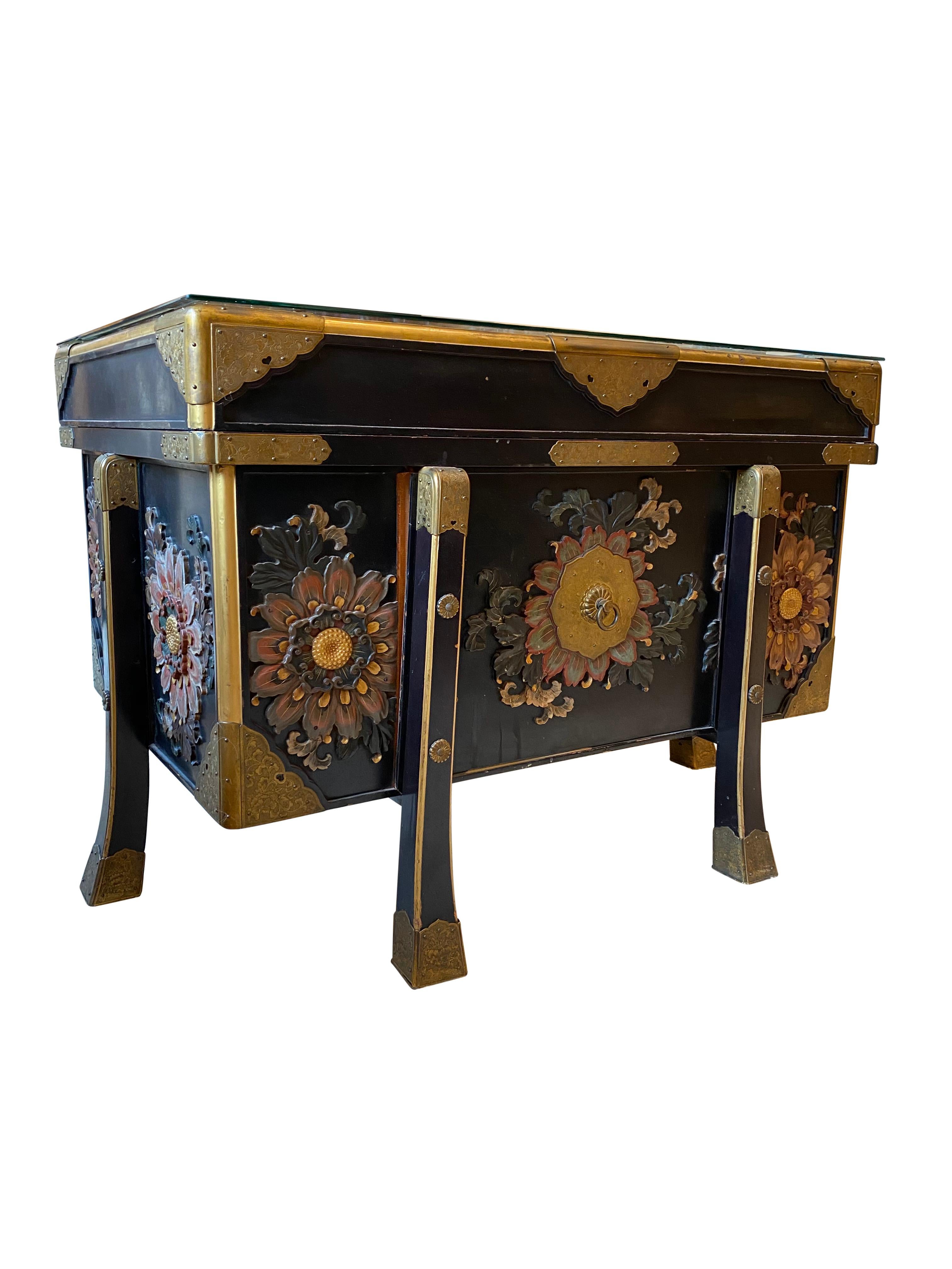 An absolutely stunning large Japanese black lacquered storage chest, 19th century. This chest is offered with superb hand carved wooden plum and cherry blossom flowers, and spectacular floral mounts. Positive meanings of flowers in China are Orchids