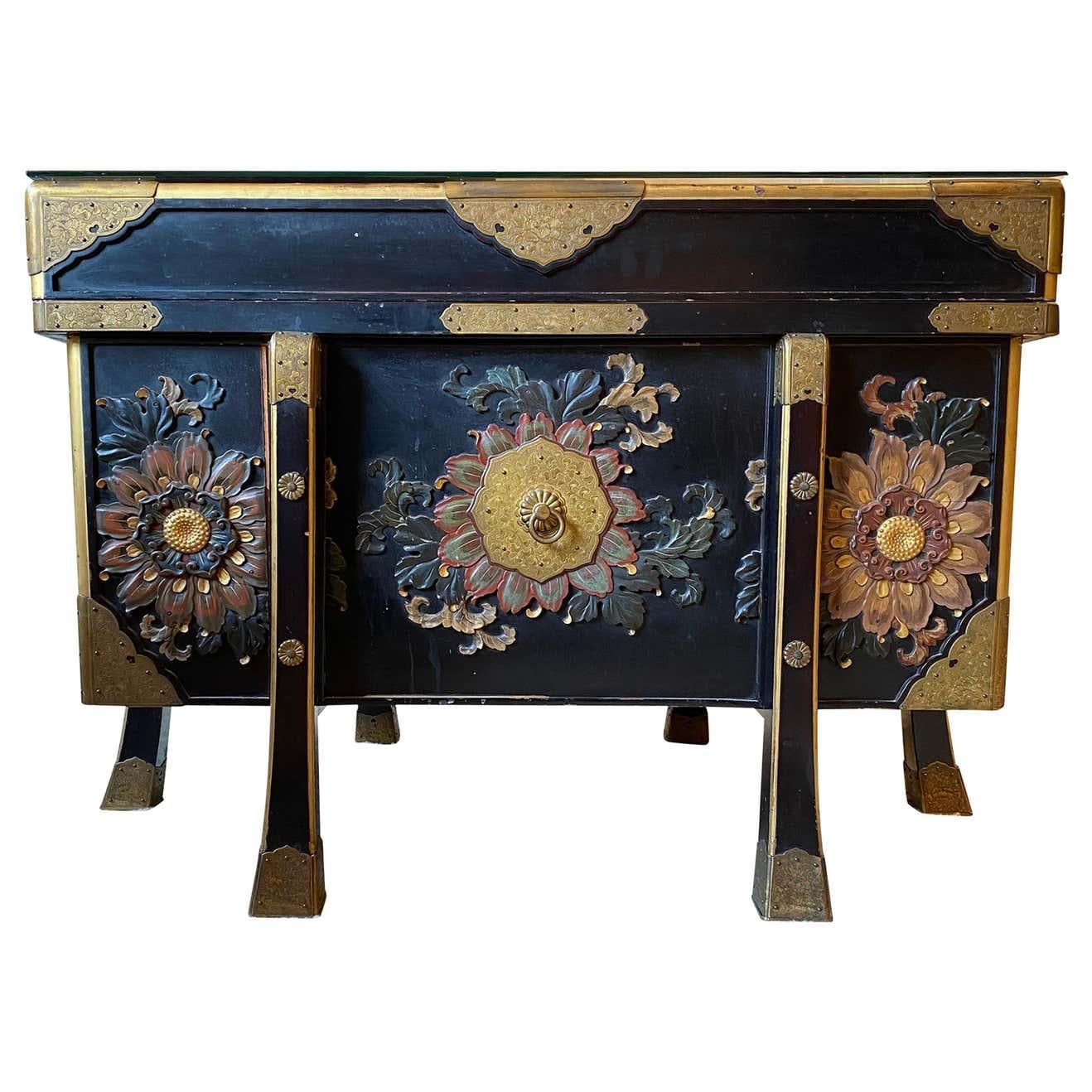 An absolutely stunning large Japanese black lacquered storage chest, 19th century. This chest is offered with superb hand carved wooden plum and cherry blossom flowers, and spectacular floral mounts. Positive meanings of flowers in China are Orchids