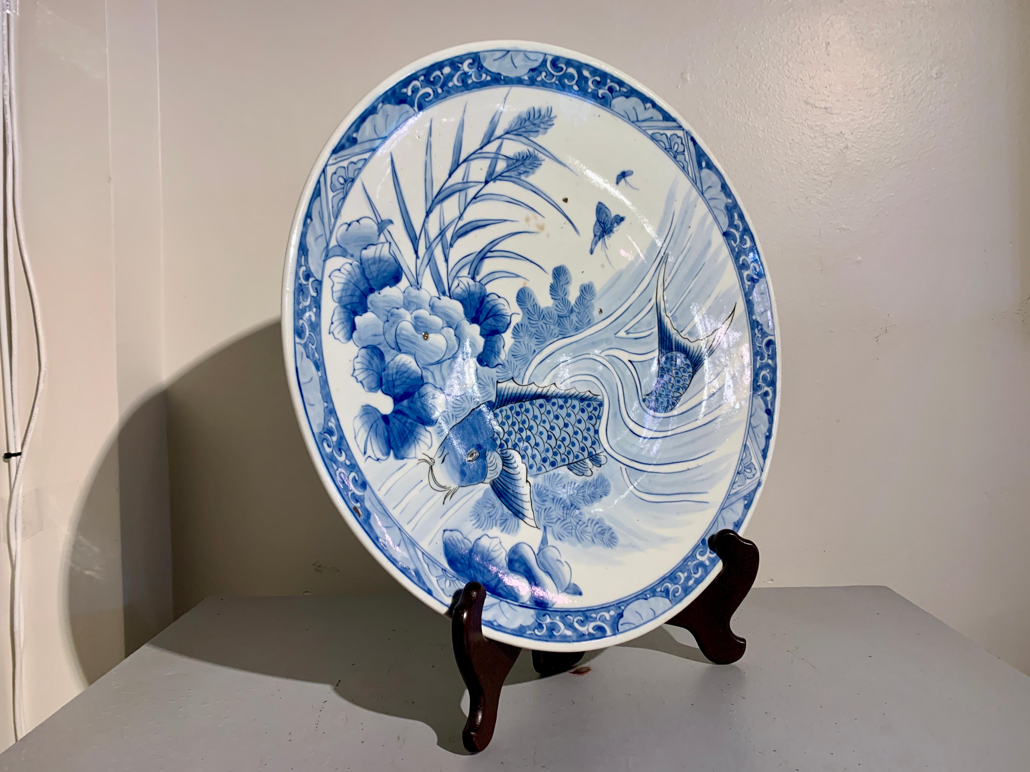 A large Japanese blue and white decorated Arita porcelain charger, Edo Period, early 19th century, Japan.

The large and shallow blue and white Arita porcelain charger measures 18 7/8