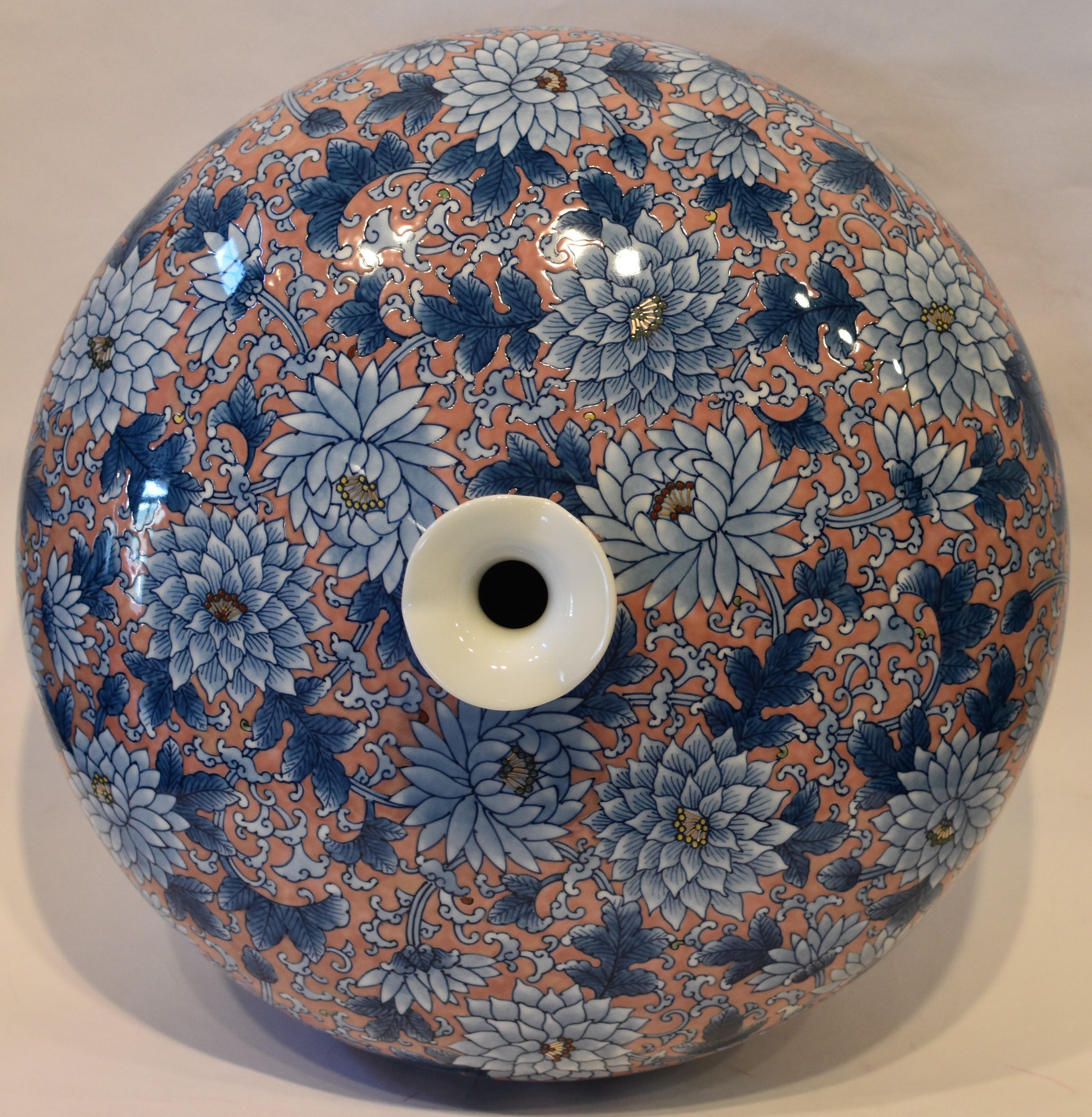 Unique large contemporary decorative porcelain vase, hand painted on the finest Arita porcelain boasting an exaggerated ovoid shape that provides the perfect canvas for a field of chrysanthemums in full bloom. Flowers done in shades of blue are set