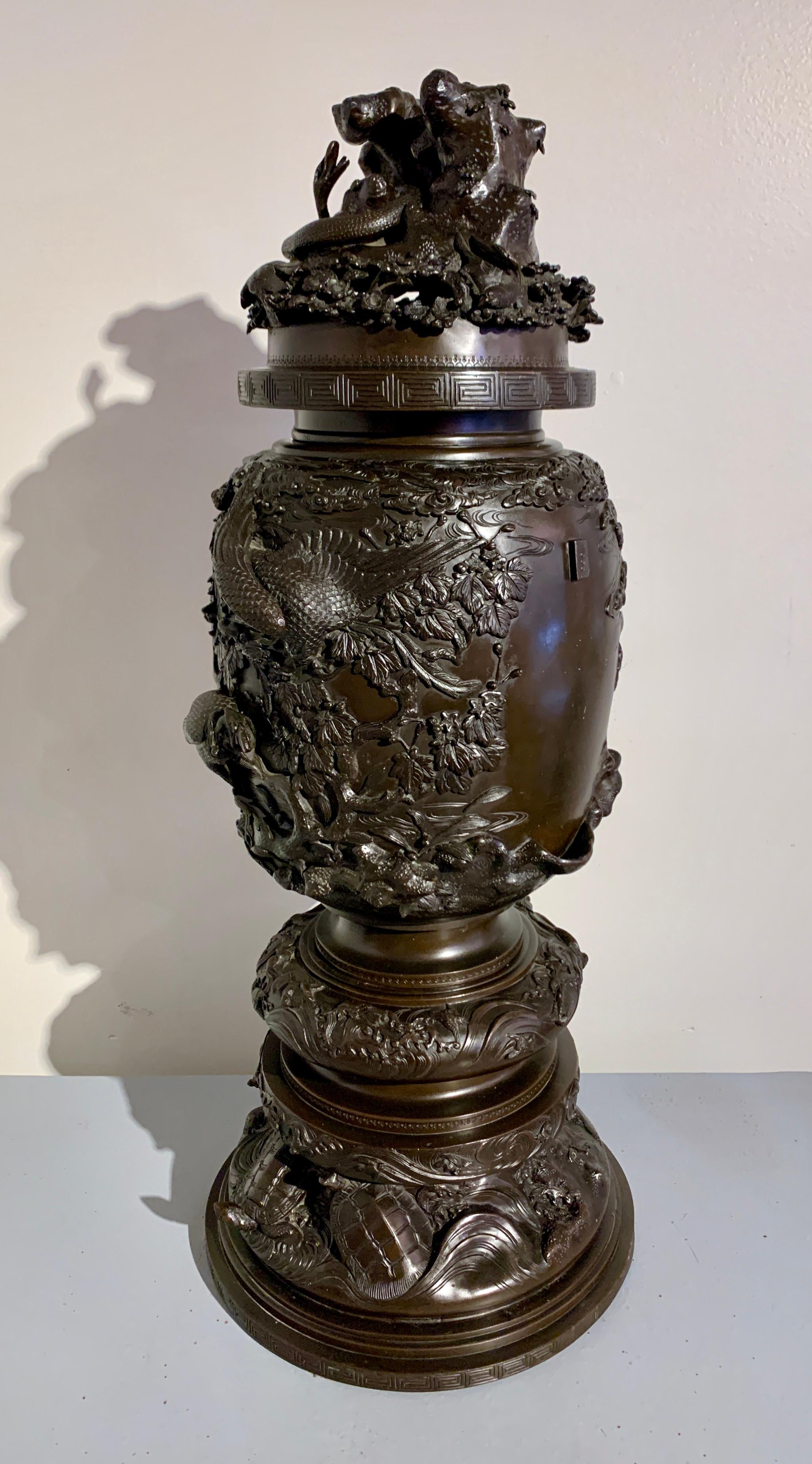 A large and fantastic Japanese cast bronze incense burner, koro, with high relief design, Meiji period, late 19th century, Japan.

The large and tall koro cast in extremely high relief with images of birds, trees, water and turtles. 
The censer