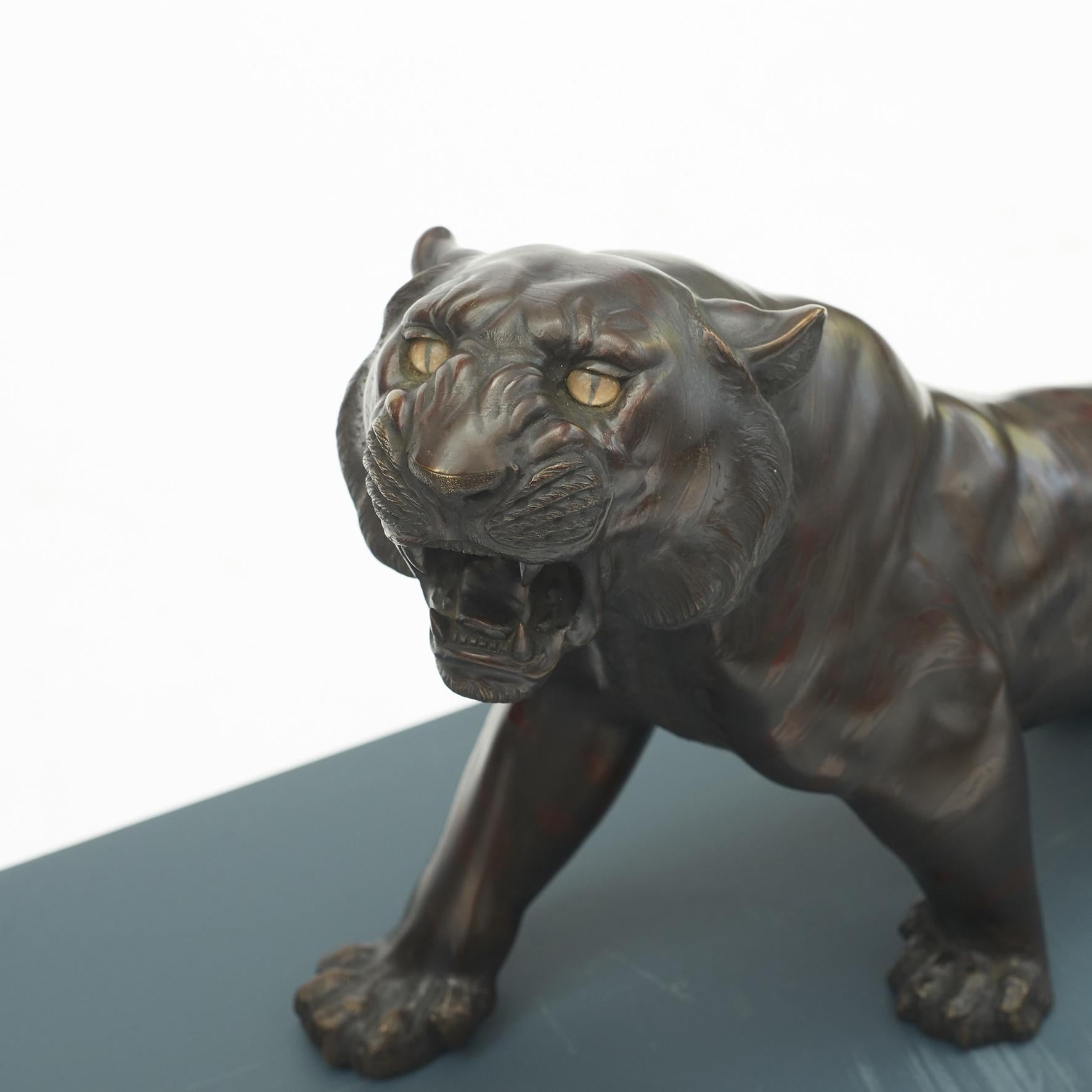 Large Japanese patinated bronze tiger with inset glass eyes.
Meiji period, 1868-1912.
The sculpture is signed with a small seal: Meiji/Taisho.
In perfect condition with a fine patina.
Weight: 6850 g.
Length: 57 cm.