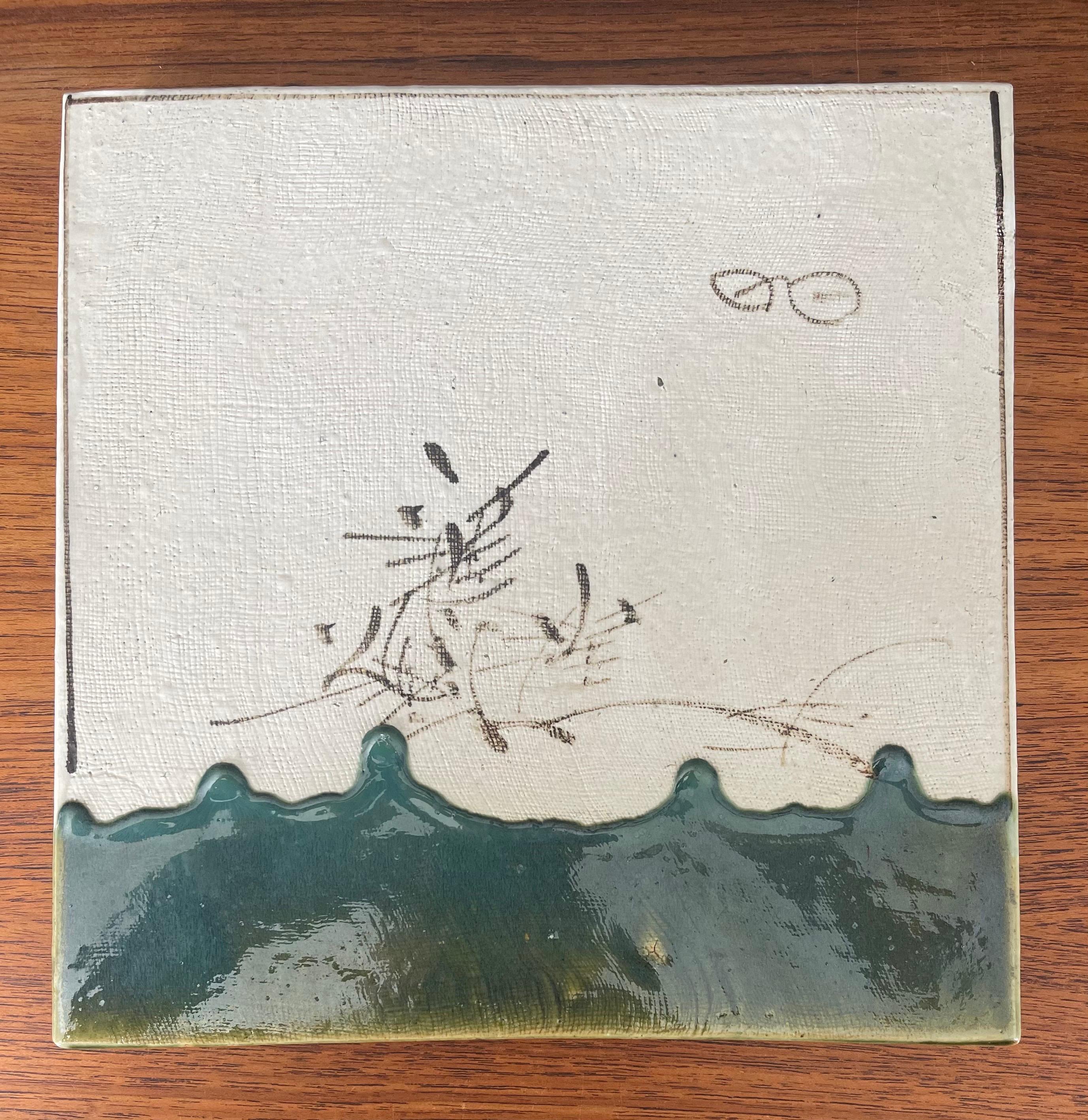A very cool large Japanese ceramic trivet, circa 1970s. The piece is made of high gloss ceramic and has a hand painted design. The trivet is in good vintage condition and measures 10.75