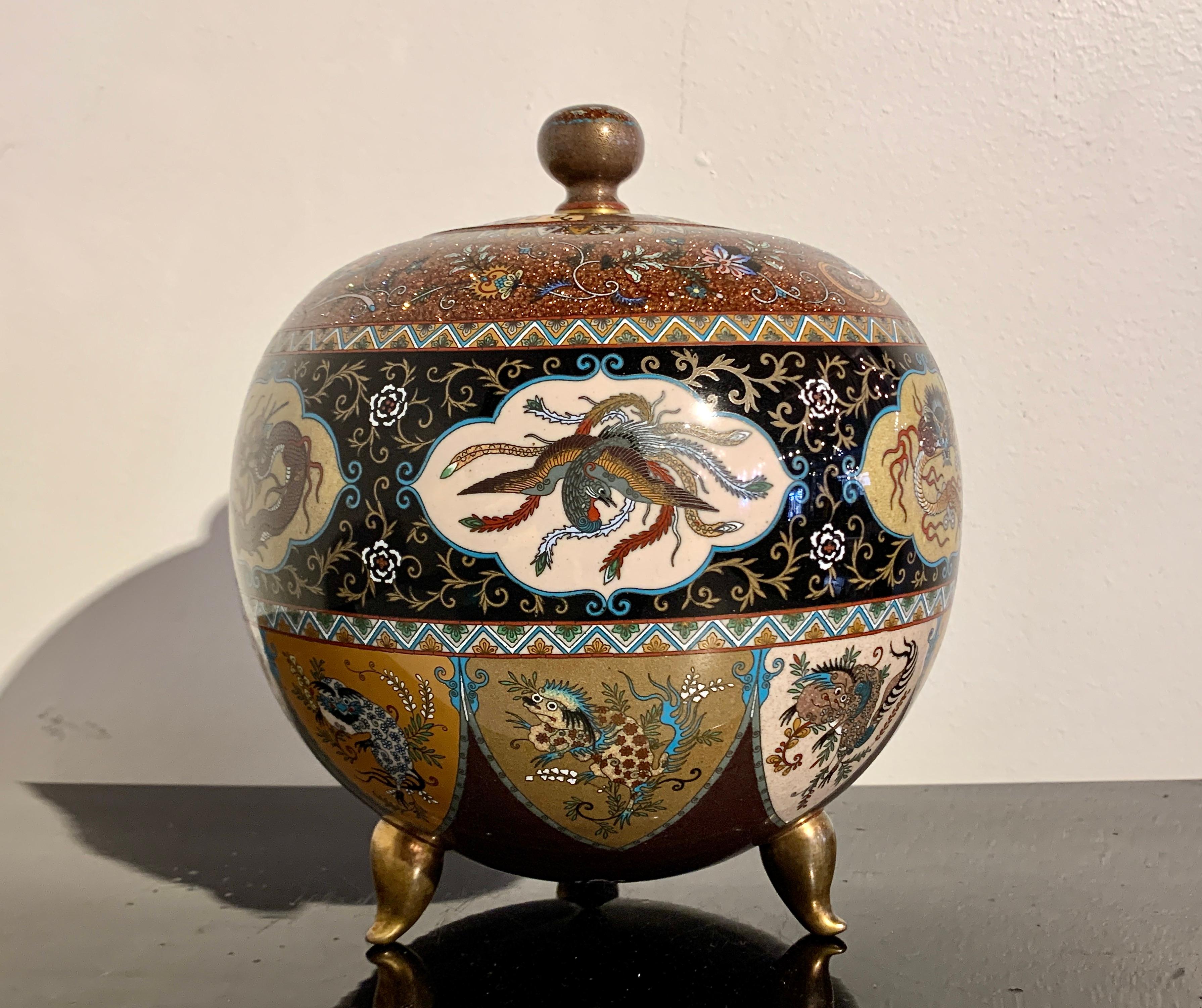 A spectacular large Japanese chakinseki cloisonné globular jar and cover, in he style of Namikawa Yasuyuki, Meiji period, circa 1900, Japan.

The jar with a spherical body supported by three, comma-shaped feet formed as magatama. Magatama are