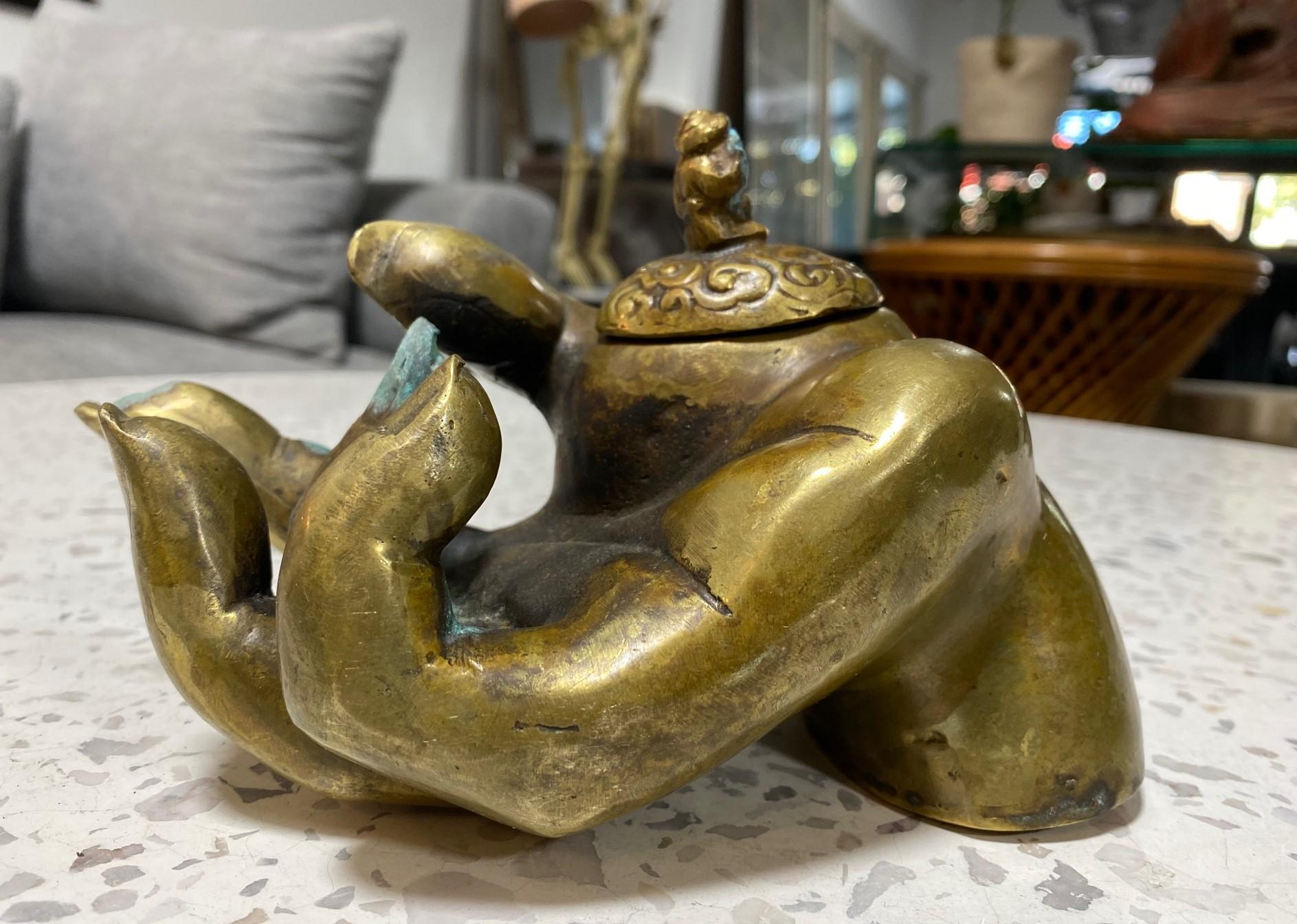 A quite fantastic, rather unique, and unusual bronze Buddha Deiety hand sculpture ( making the mudra hand gesture) that also serves as an incense censer.  We believe it is likely Japanese or Chinese.  

The sculpture is signed/marked on the base