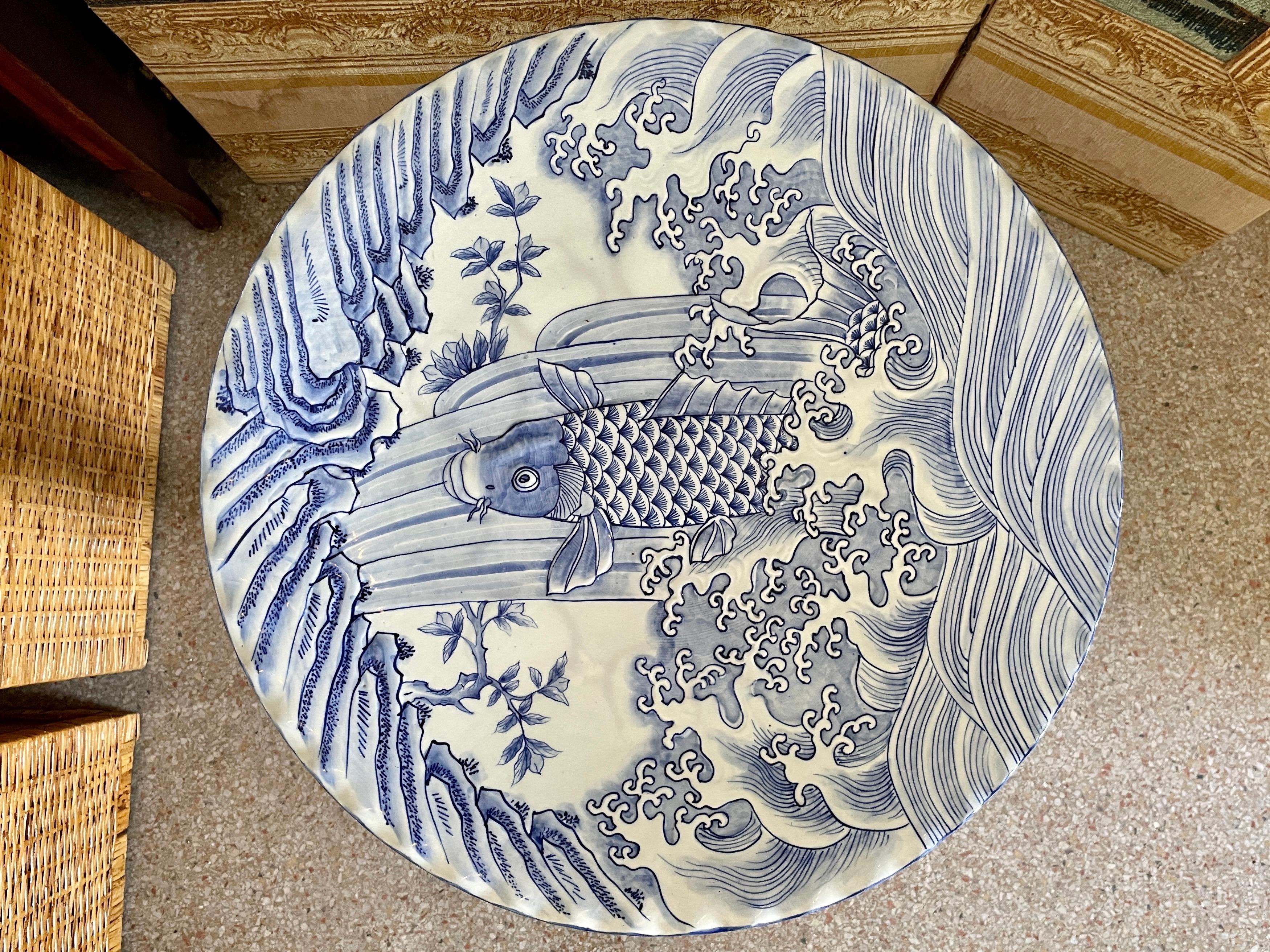 Lovely Japanese large ceramic serving platter with Blue and White fish and sea drawings. Could be a great decorative platter for your interiors and parties. Very rare size and scale.