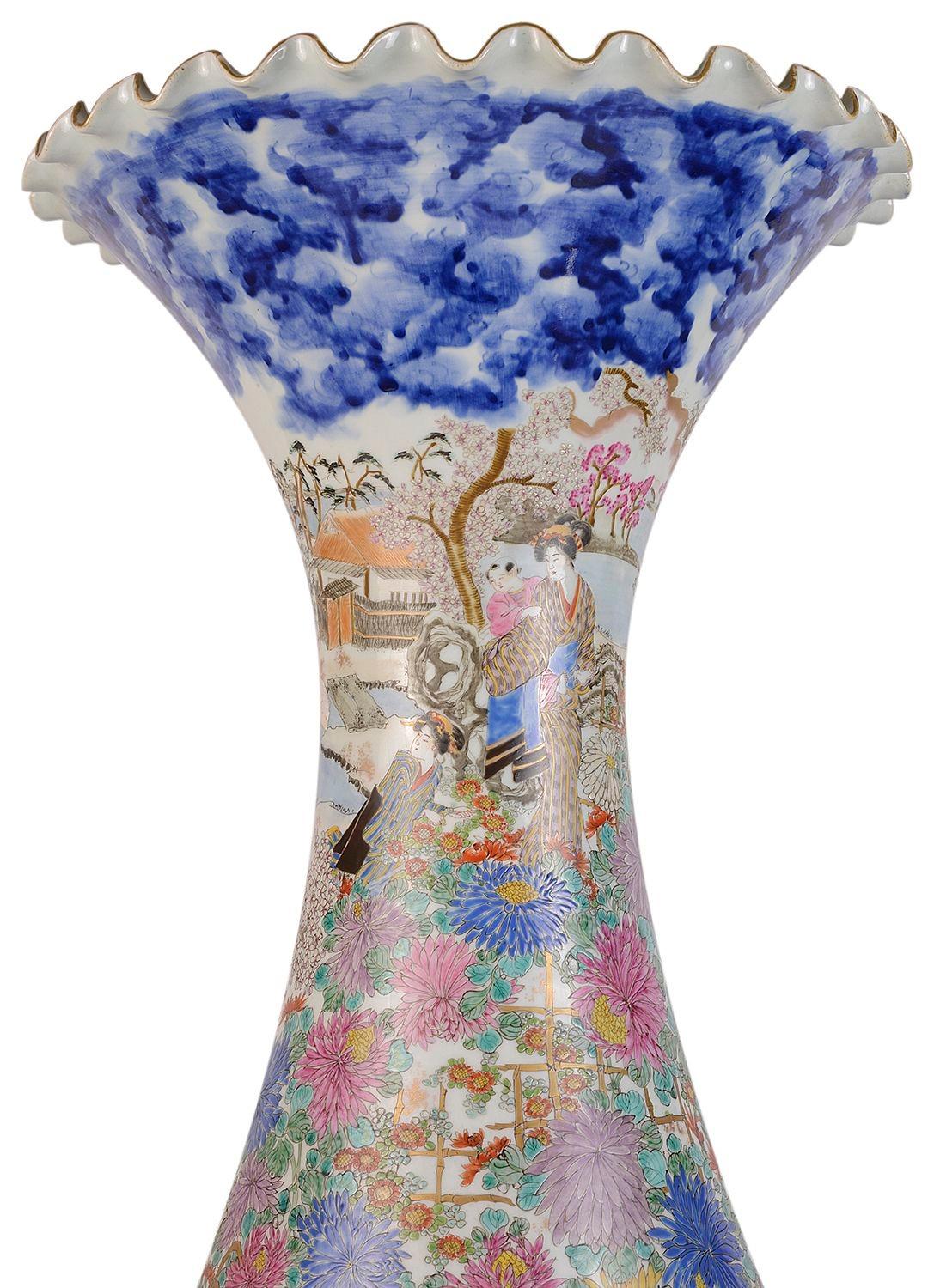 An impressive, good quality late 19th Century Japanese Kutani porcelain crumple edged vase, having boarders of blue and white clouds above and stormy waves below, three men in boat looking up at women and child walking through the exotic gardens.
 
