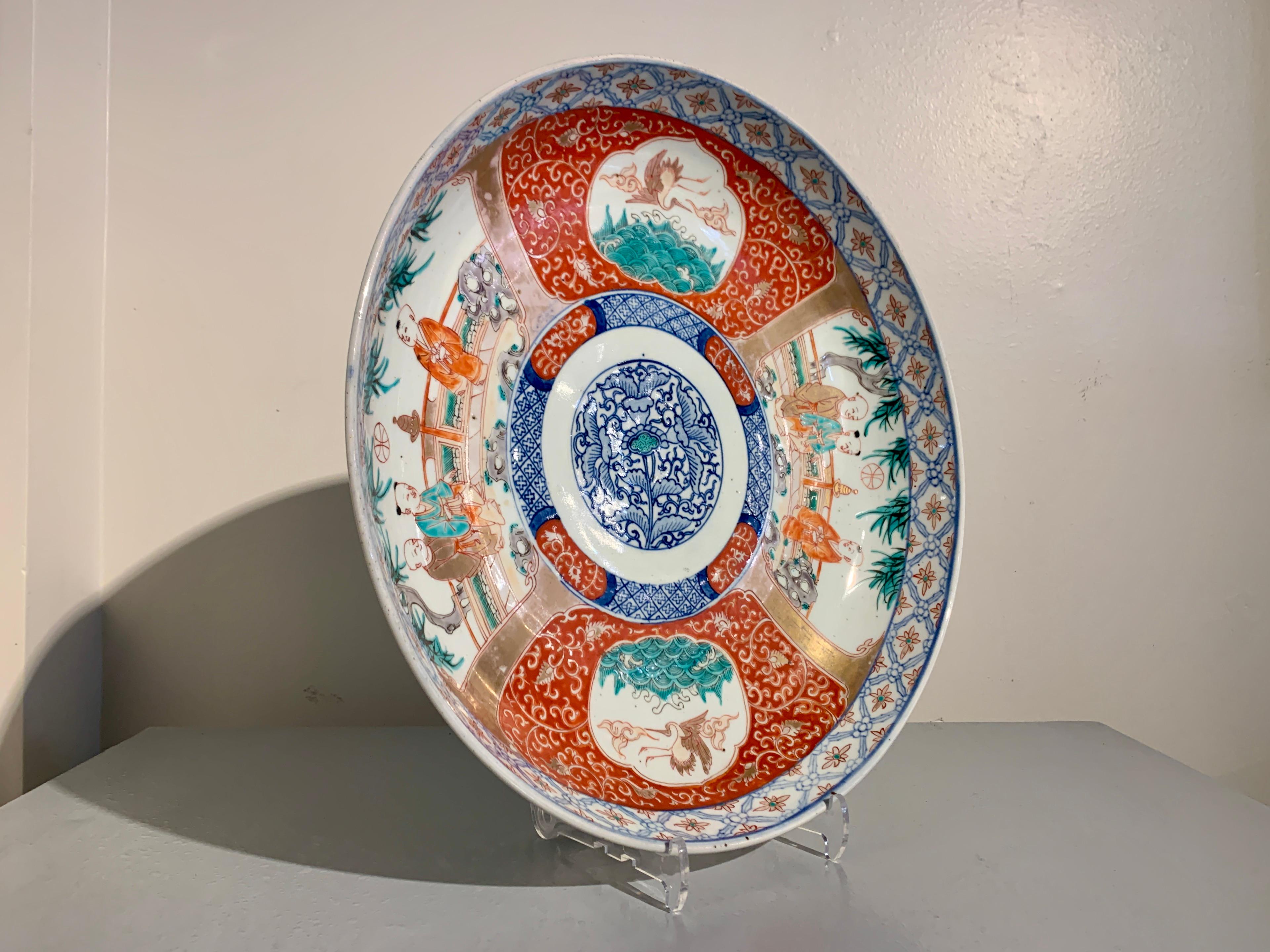 A large and charming Japanese imari charger with Chinese boys, Edo to Meiji Period, mid 19th century, Japan.

The large porcelain charger measuring 16