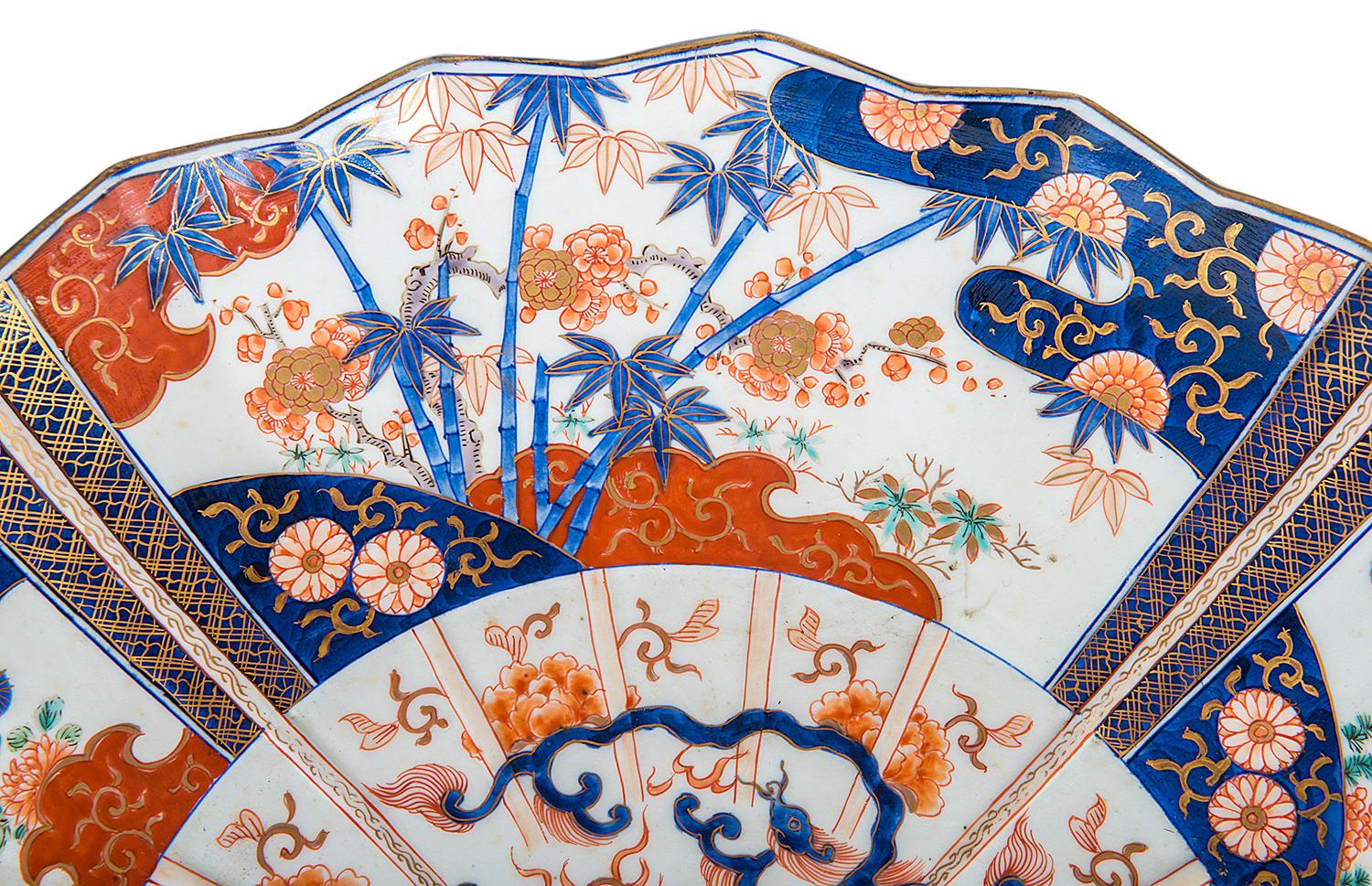 A very good quality late 19th century Japanese Imari charger, having four-fan shaped segmented panels each with bamboo or blossom trees, motifs and floral decoration.
