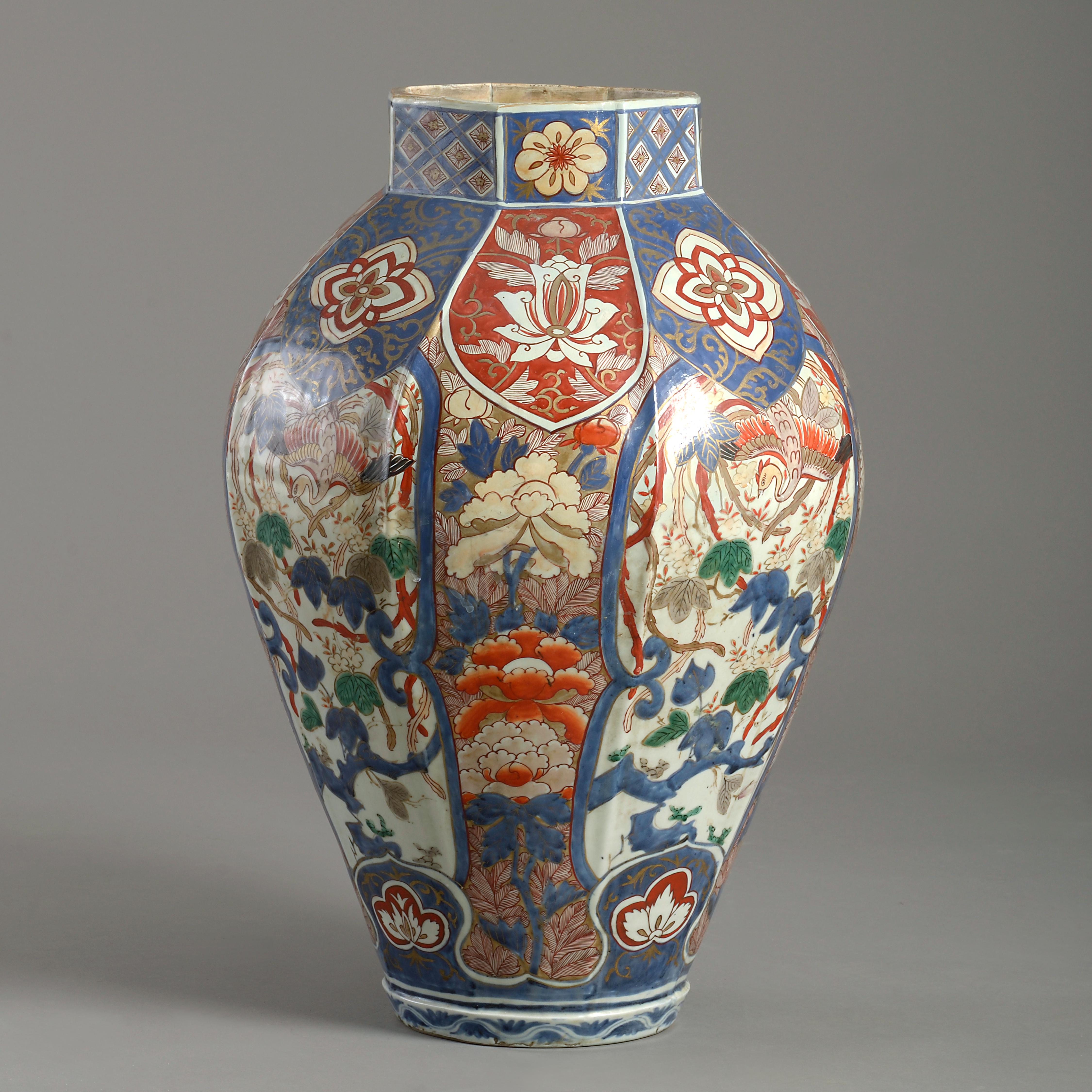 A large Japanese Imari faceted octagonal vase, circa 1700.

Decorated with panels of birds among flowering branches alternating with panels of peonies and chrysanthemum.