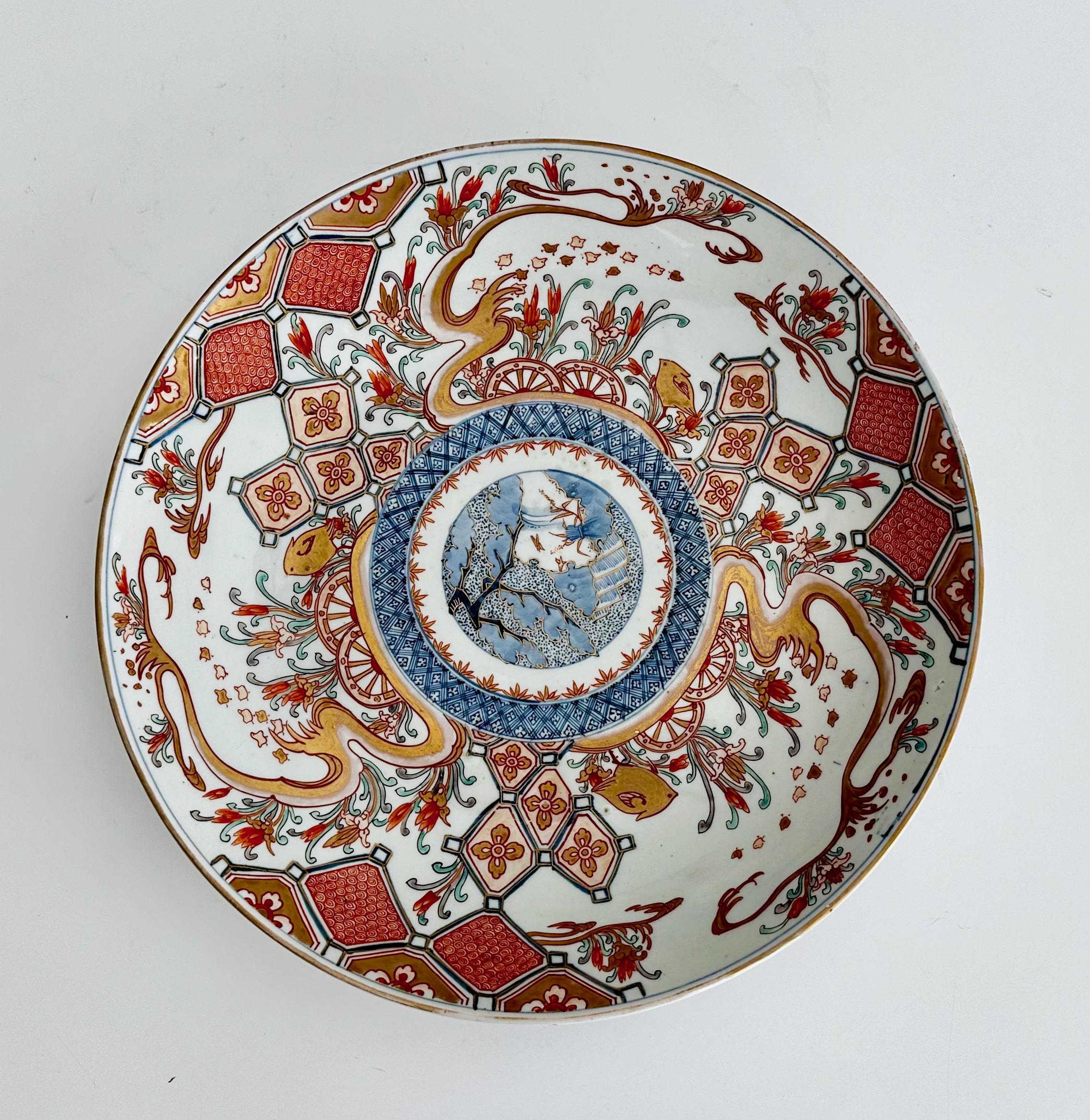 Hand painted porcelain Japanese Imari charger plate with birds, tree branches and floral motif.