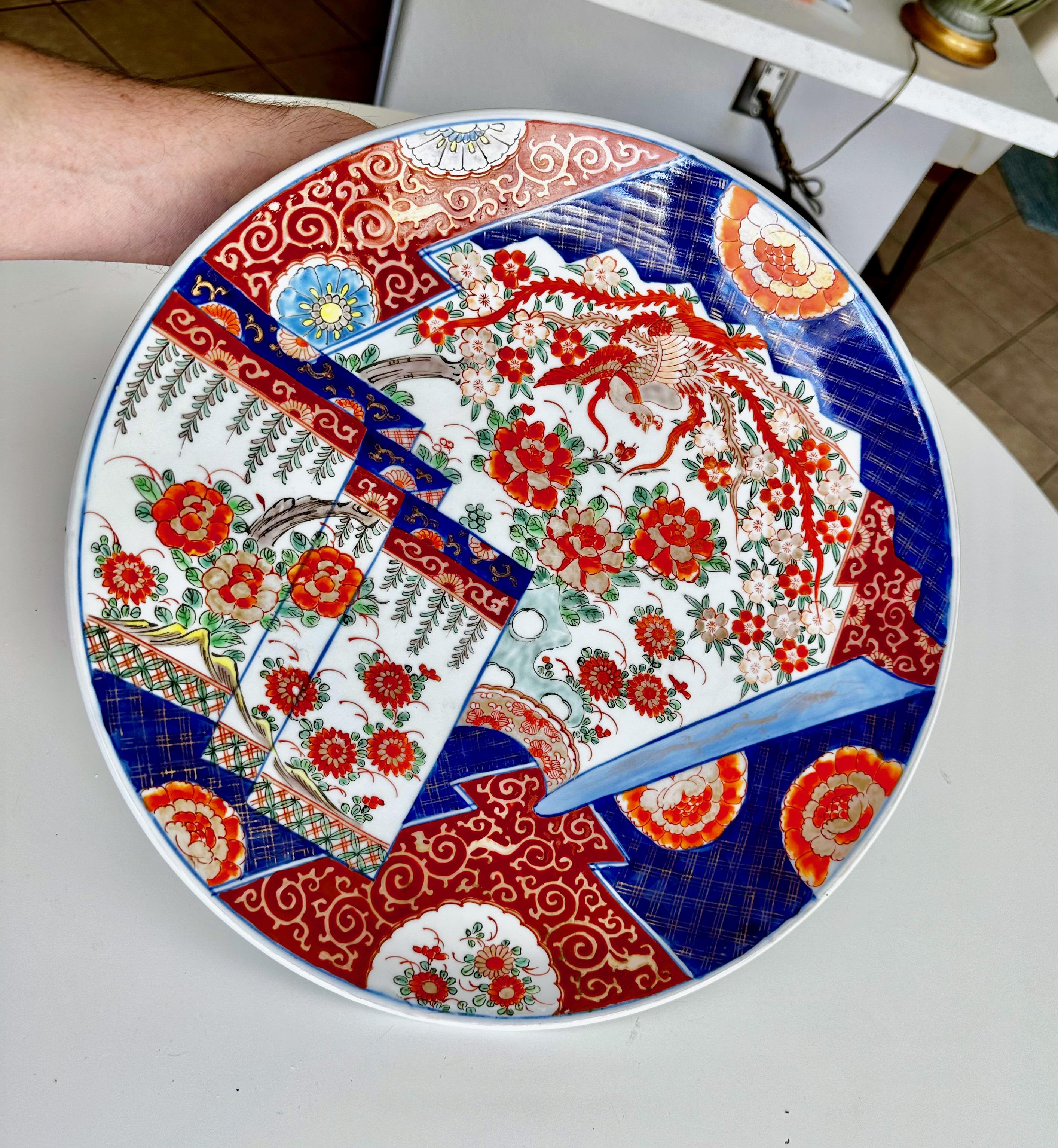 Hand painted porcelain Japanese Imari charger plate with birds and floral motif.