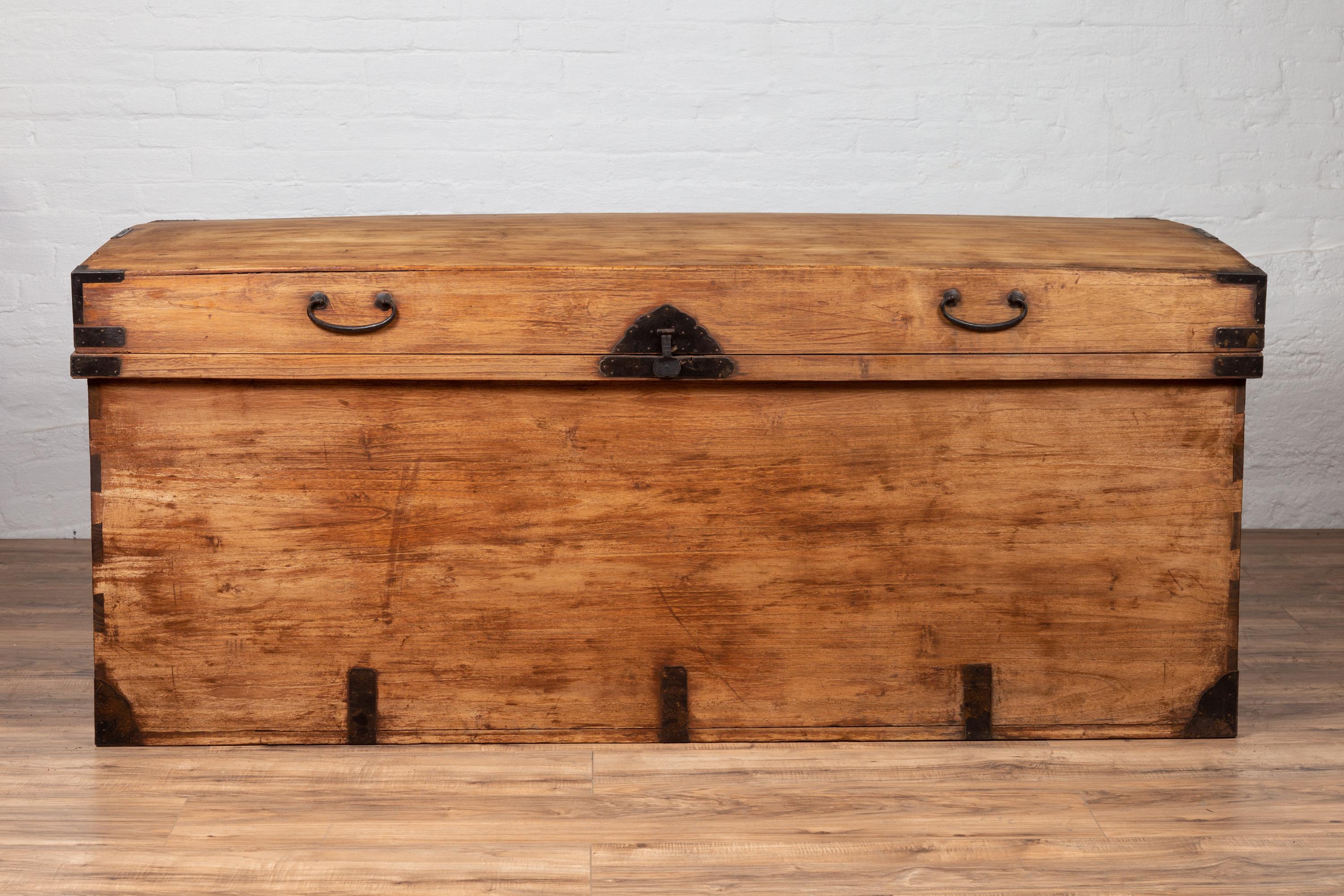 An antique Japanese large kimono storage chest from the early 20th century, with iron cut hardware and dovetail construction. Born in Japan during the early years of the 20th century, this stunning large kimono chest is a rare find! Presenting a