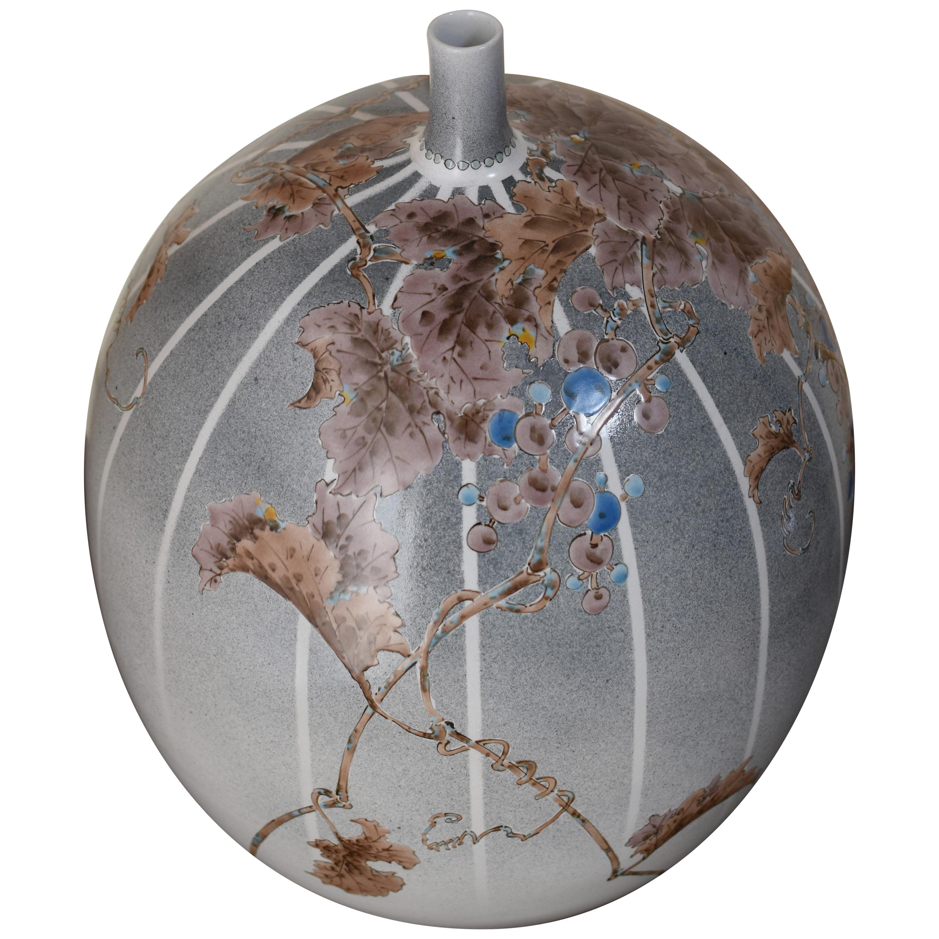 Exceptional Japanese contemporary decorative porcelain vase, stunningly hand painted in brown on a stunning egg shape body in beautiful background with stripes on a blue/gray gradation. It is a masterpiece by a highly acclaimed award-winning Kutani