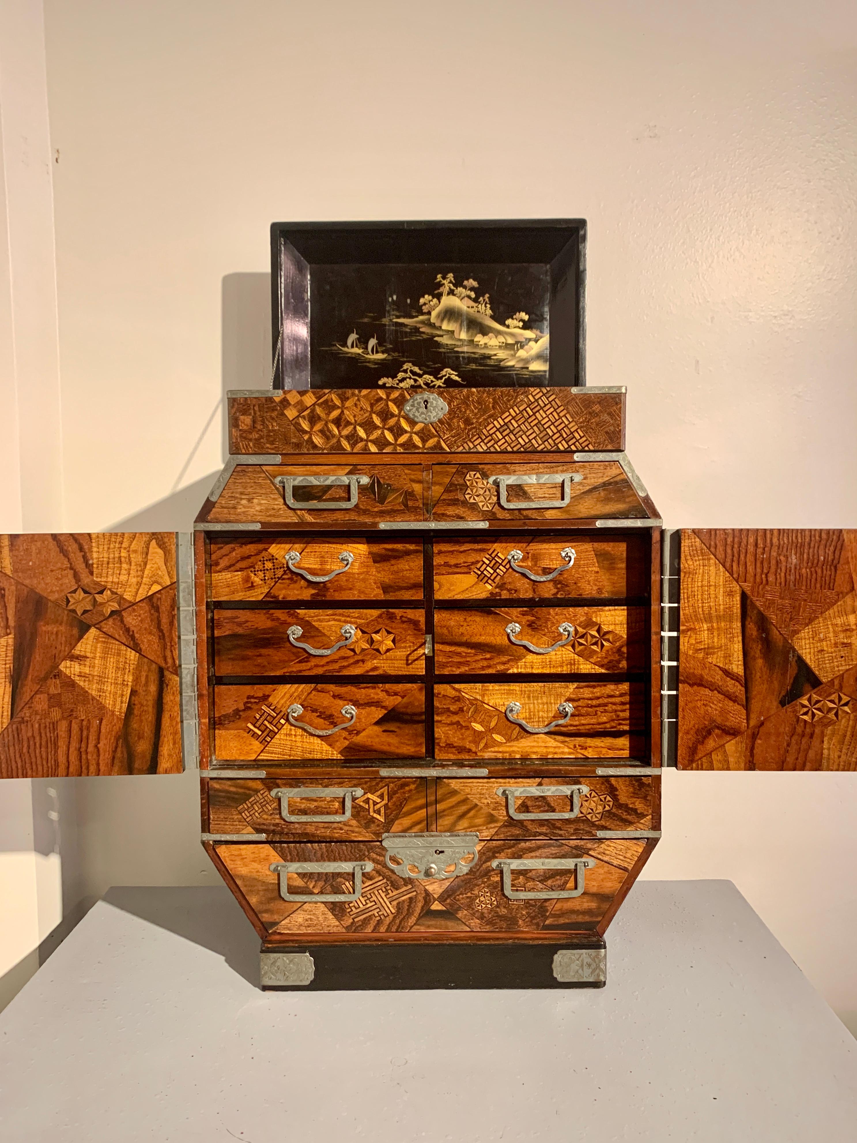 A fine and unusually large Japanese table cabinet or jewelry chest with yosegi marquetry work and lacquer paneled doors, Meiji period, late 19th century, Japan. 

The oversized table cabinet of irregular octagon shape, with a lift top featuring a