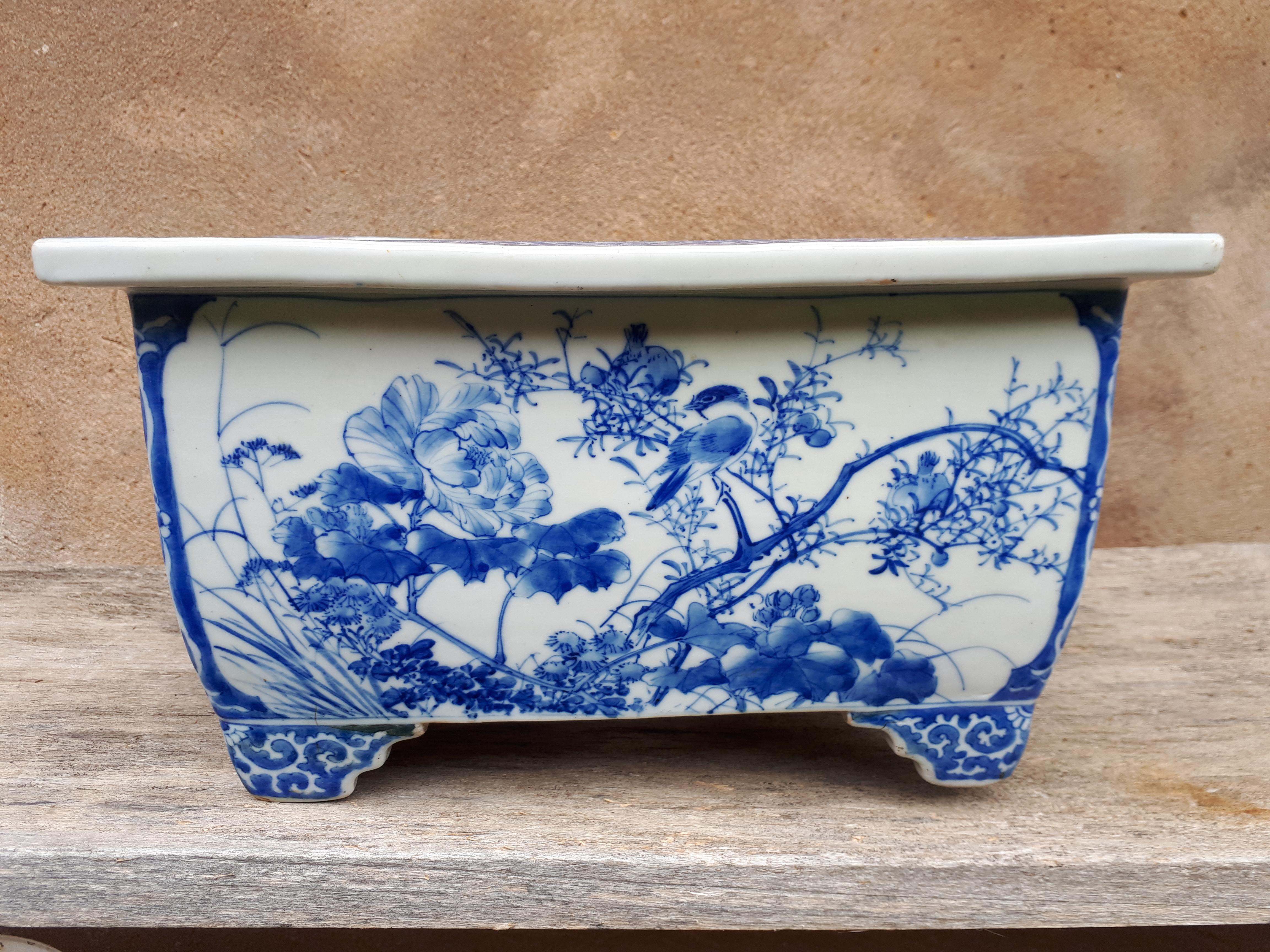 Rectangular section porcelain plant pot with blue underglaze decoration of flora and birds.
Japan, late 19th century.