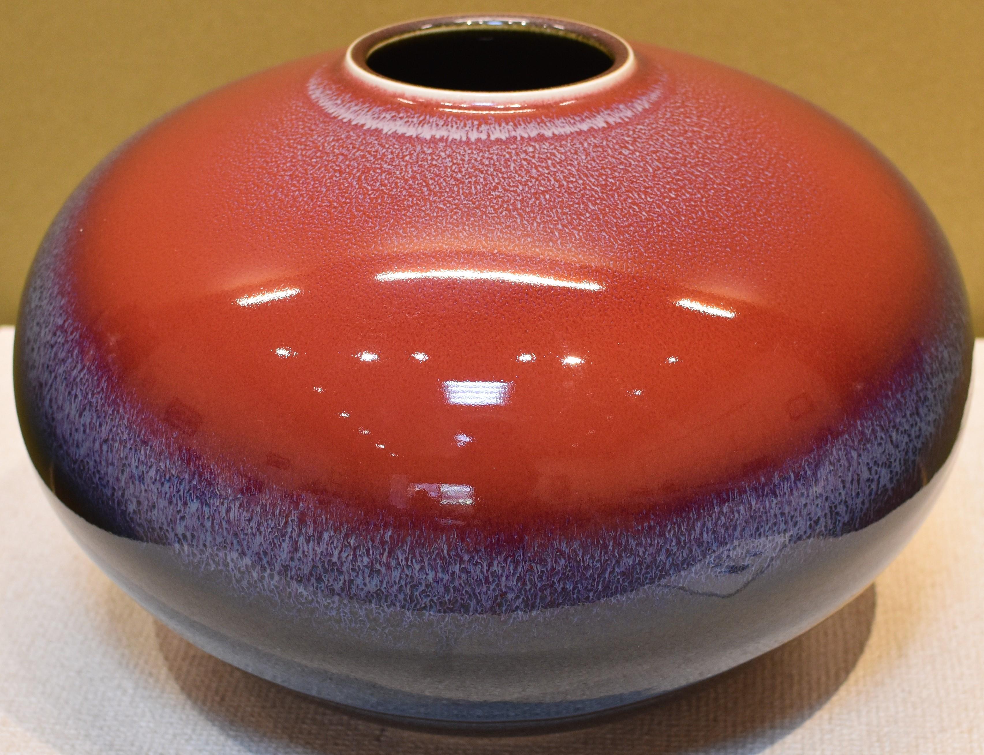 extraordinary museum quality hand-glazed Japanese contemporary decorative porcelain vase, an exhibition piece in a striking shape in deep red, blue and black, by master porcelain artist of the Arita-Imari region of Japan. The artist’s basic