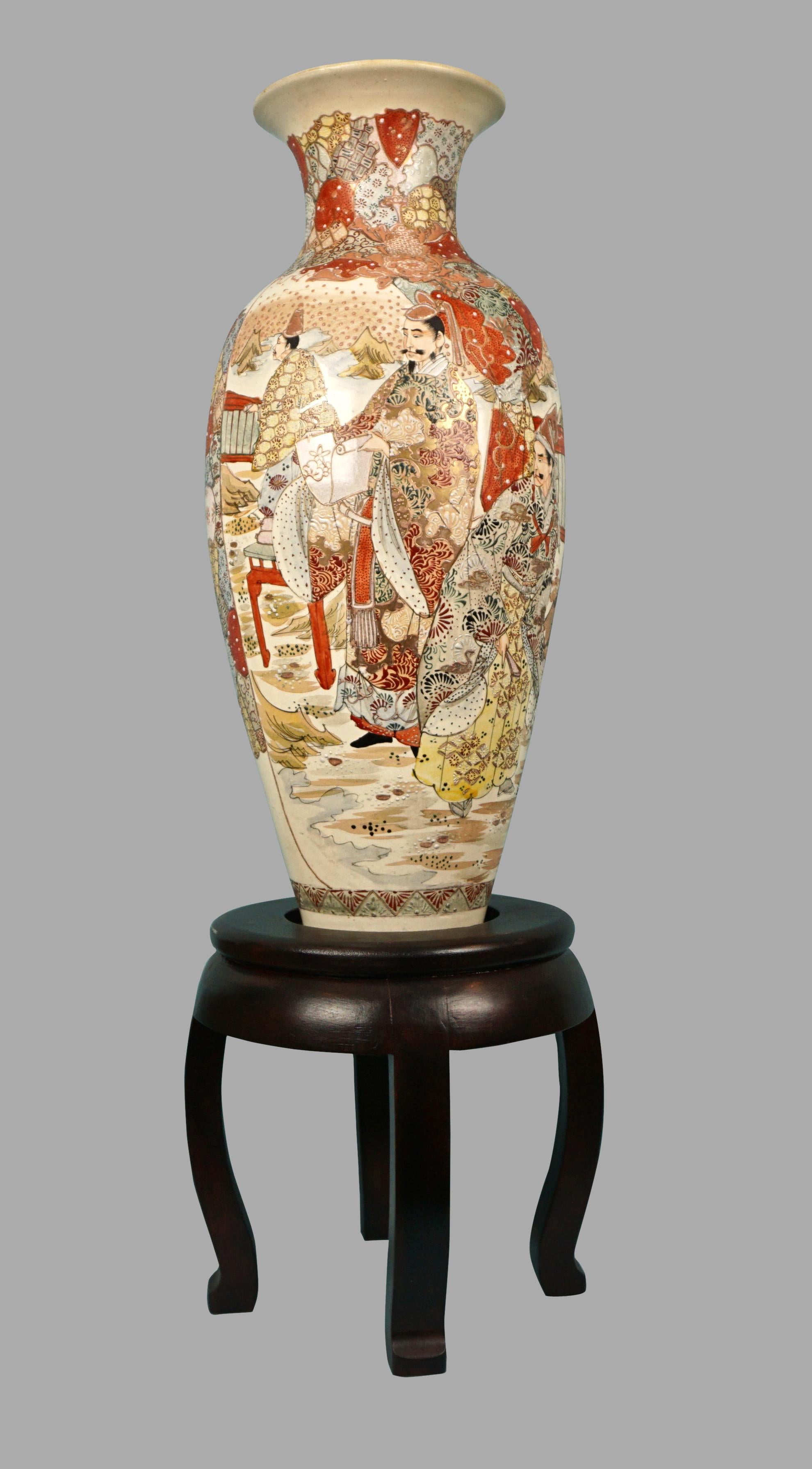 An impressive and large Satsuma enameled earthenware vase decorated overall in tones of orange, yellow, pale green, light brown and black on a cream field with traditionally dresses samurai on one side and elegantly dressed men on the other, all in