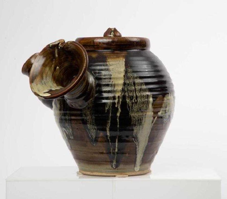 A oversized pottery art piece in the form of the single-handle tea pot (called Yokode Kyusu in Japanese), serves as a viewing sculpture rather than a practical utensil. Created in the style of Chosen (korean) Karatsu style ware coated with straw ash