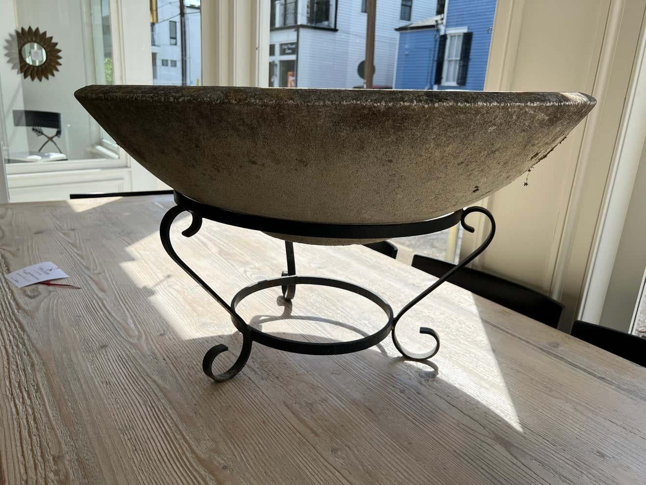 Very large concrete planter on a beautiful wrought iron base. Appropriate for indoor or outdoor use.