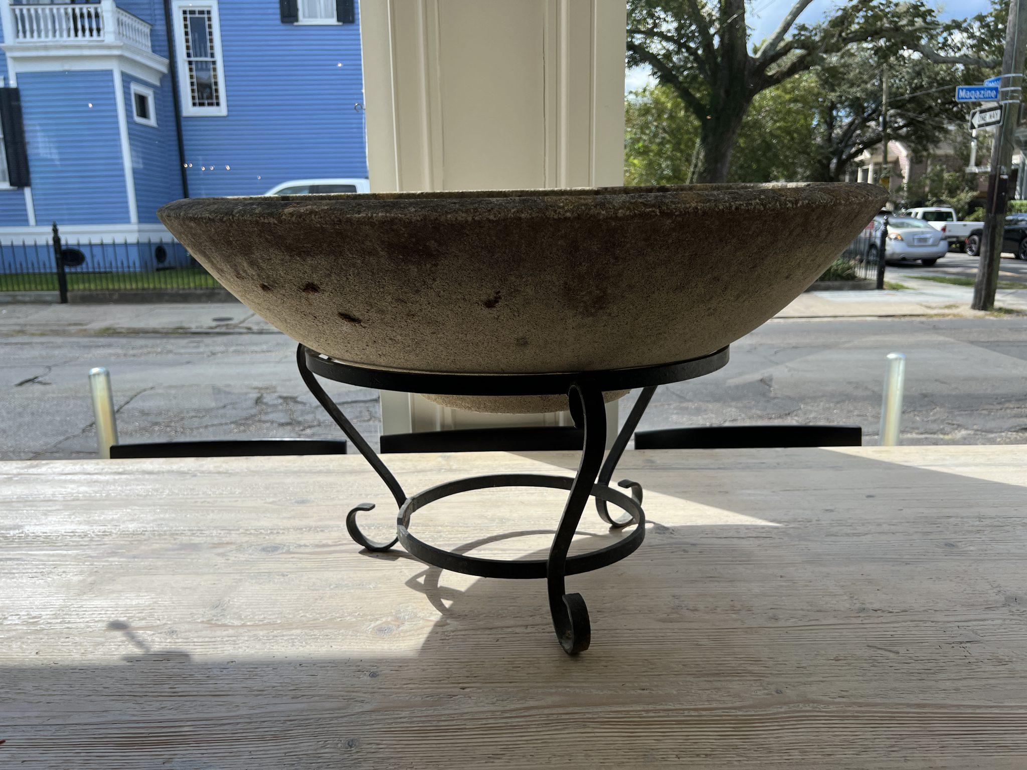 Very large concrete planter on a beautiful wrought iron base. Appropriate for indoor or outdoor use.