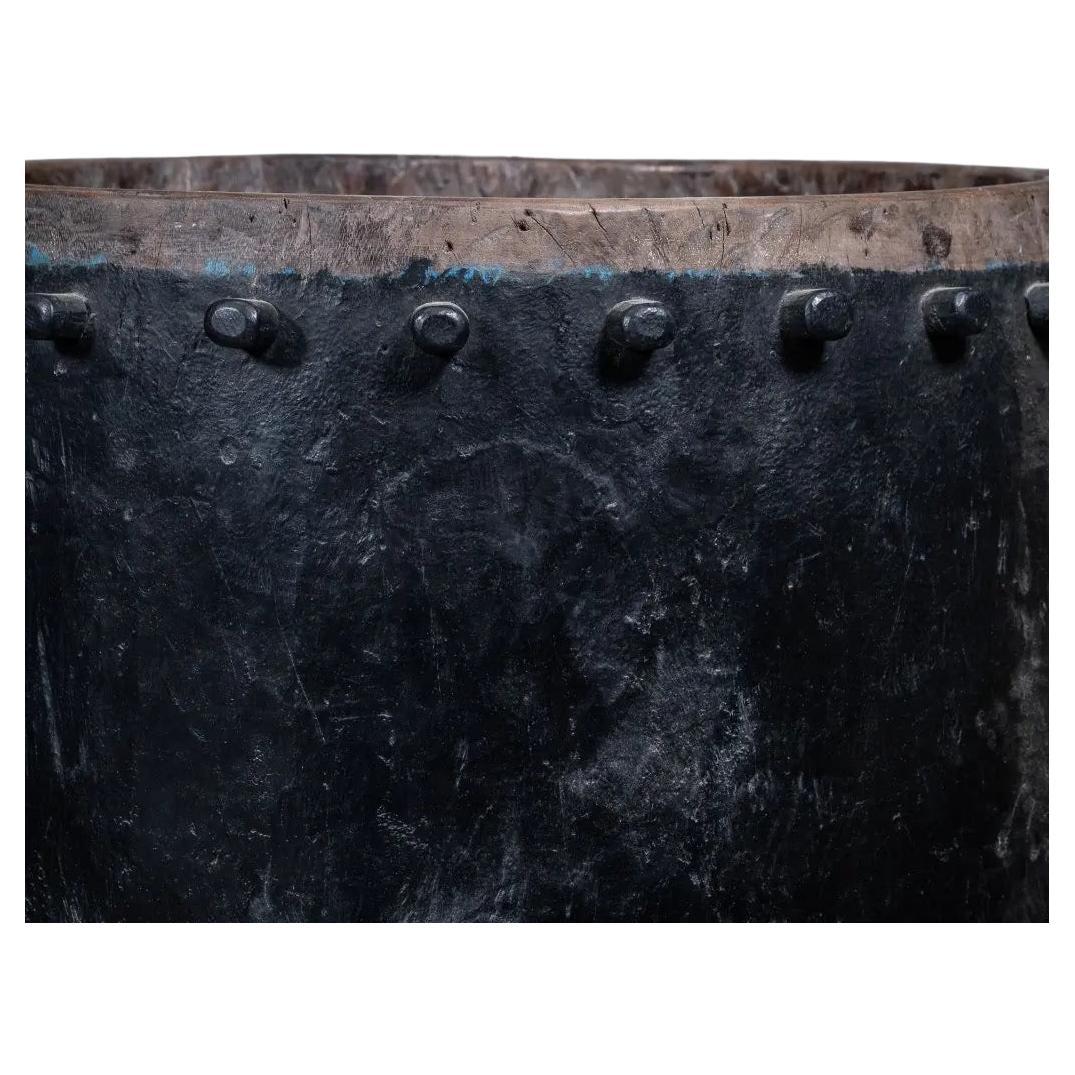 This large Javanese drum pot in hand-carved black teak embodies the strength and beauty of traditional Indonesian craftsmanship. Originally a musical instrument, it retains the wooden protrusions that once tightened its resonant skin—now transformed