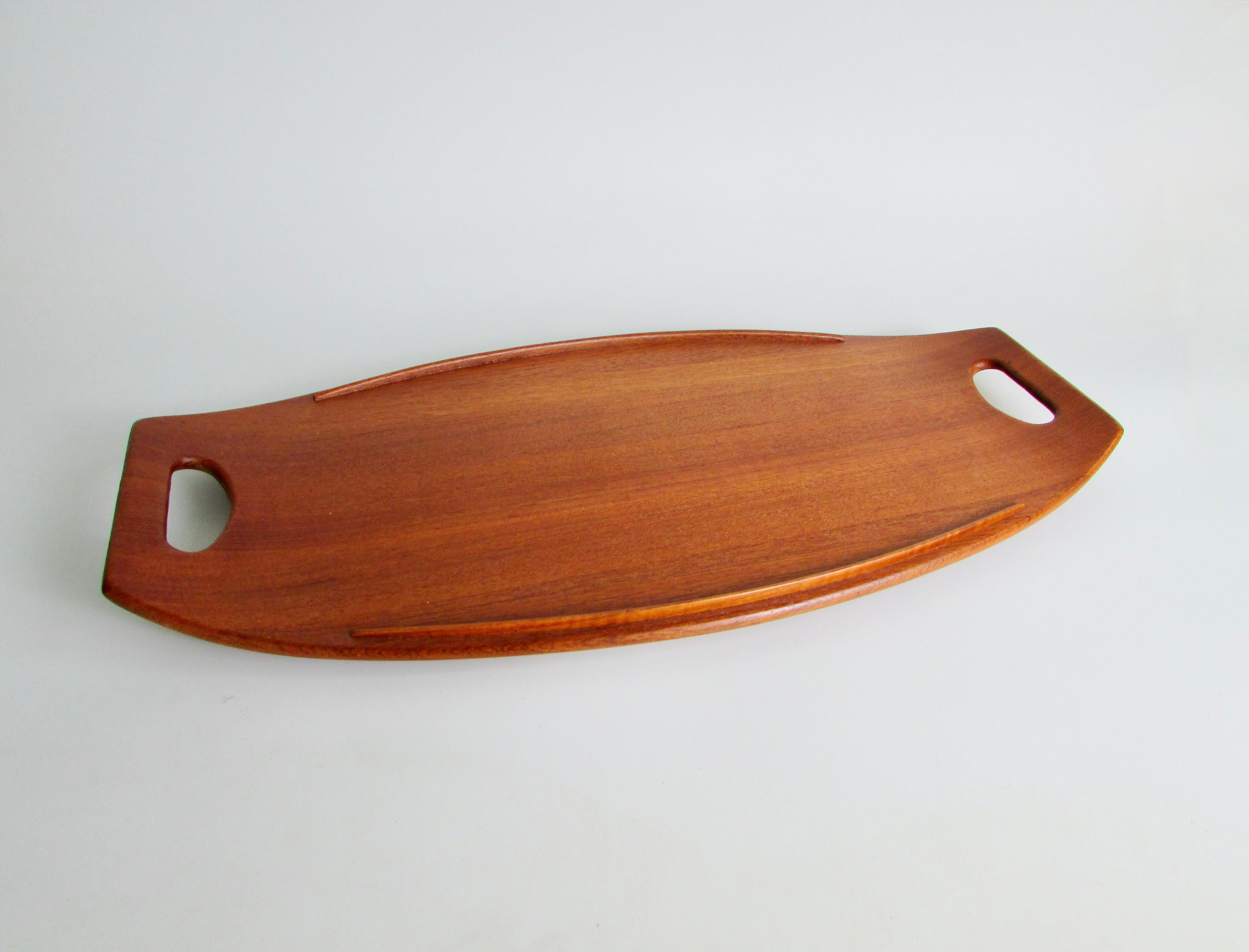   Dansk teak tray with duck logo marked Dansk Designs JHQ  Denmark   . Very nice possibly un touched condition. Fine sculptural and functional teak tray in fine condition .