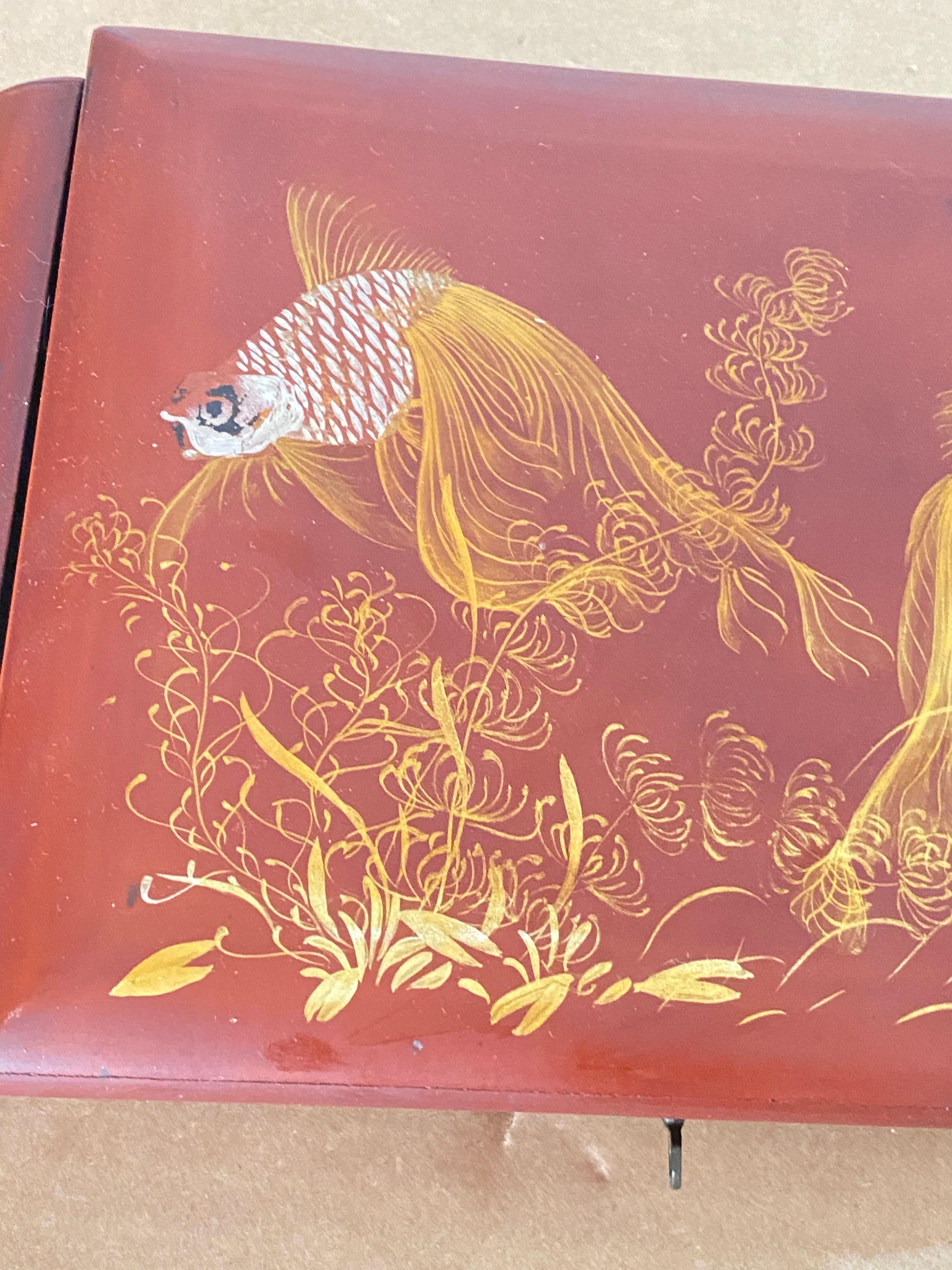 Large box from Vietnam. Manufactured at the end of the 19th century. Red in color slightly pinkish, with magnificent fish decorations in white and yellow colors. This box locks, the system works. Inside on the inner fold-out panel is a mirror that