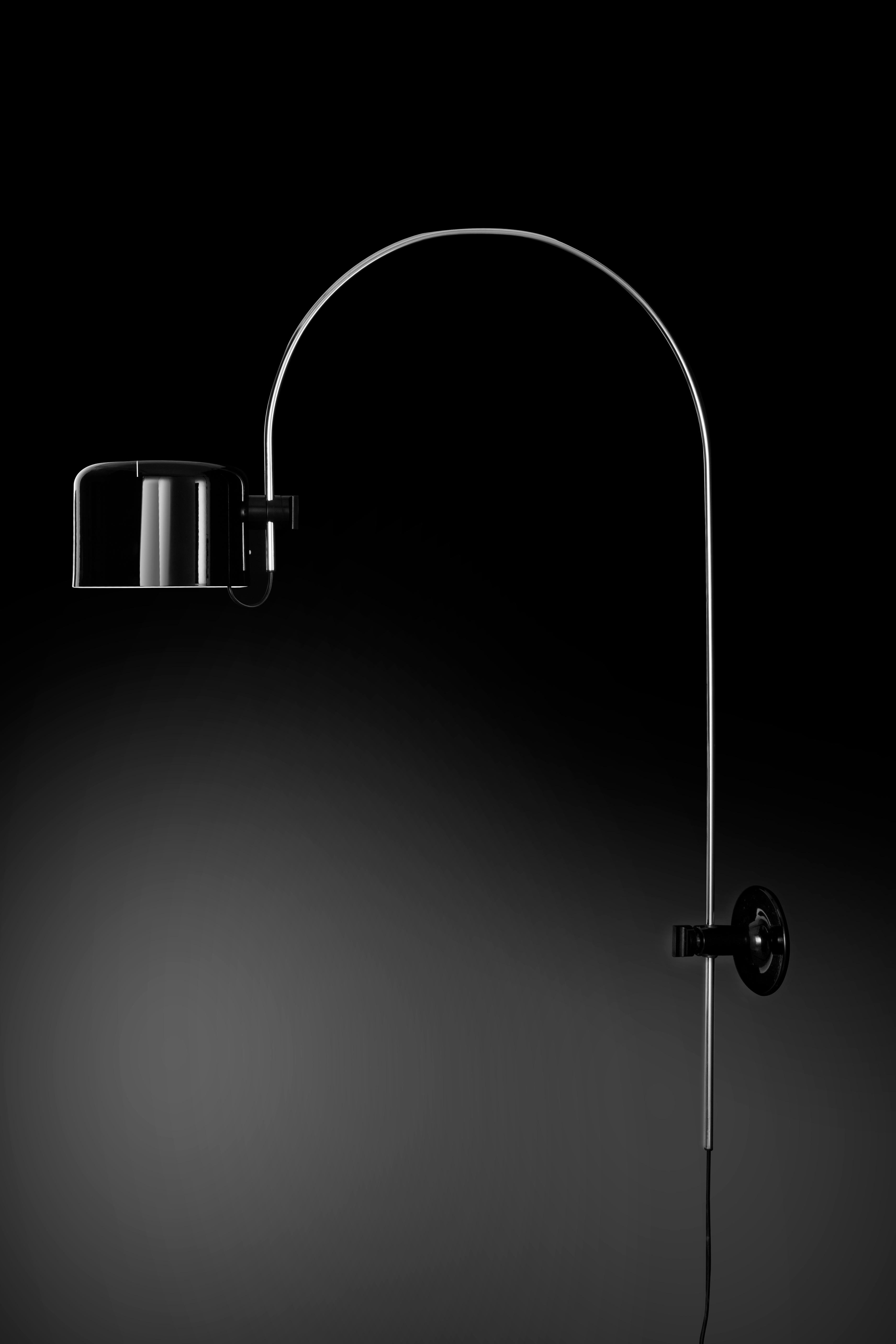 Joe Colombo Model #1158 'Coupé' wall lamp in black for Oluce. 

Executed in black metal and chrome, this is one of the most refined Minimalist Italian designs of the midcentury and an icon for Colombo. A highly adjustable wall light, the shade can