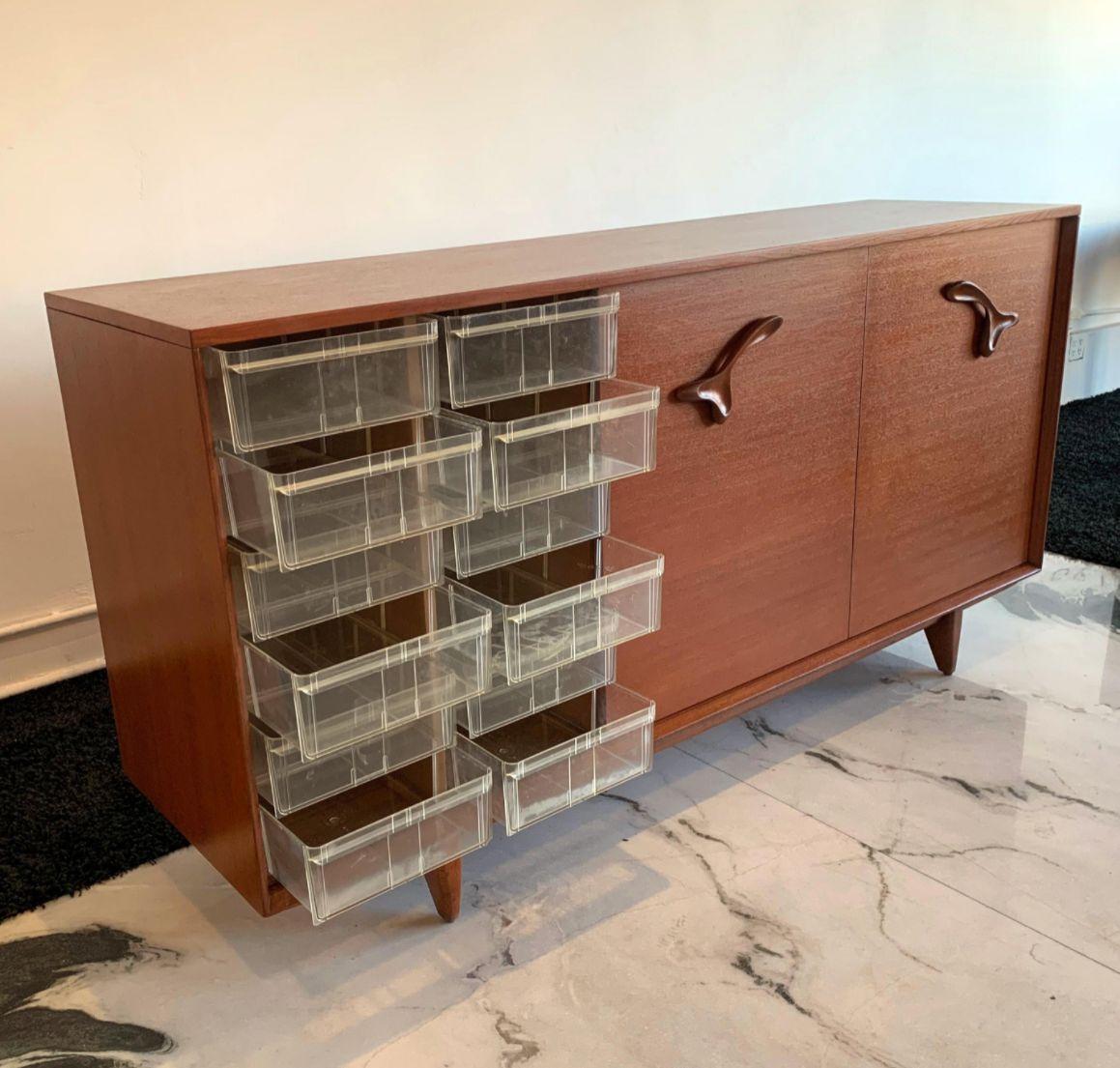 This piece is truly striking! Immediately recognizable by its amoeba style sculpted wooden handles, this John Keal for Brown and Saltman is Mid-Century Modernism at its finest. John Keal Designed in the 1950s for Brown Saltman, this expertly