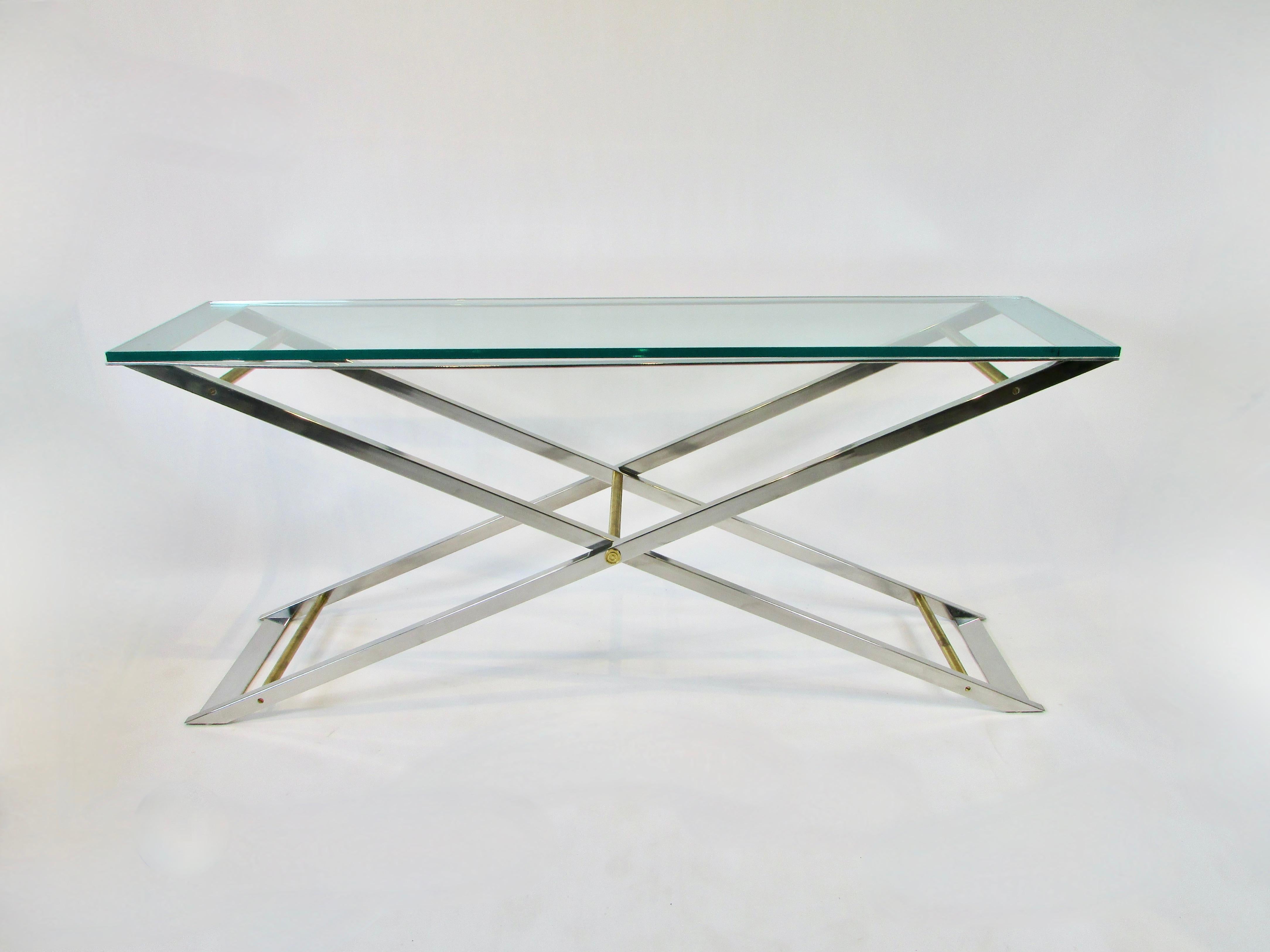 Six foot long polished aluminum stainless steel and brass console table. Designed along the lines of a John Vessey piece using multiple types of metal. Chrome frame is in fine condition. Brass stretcher bars show patina. 3/4