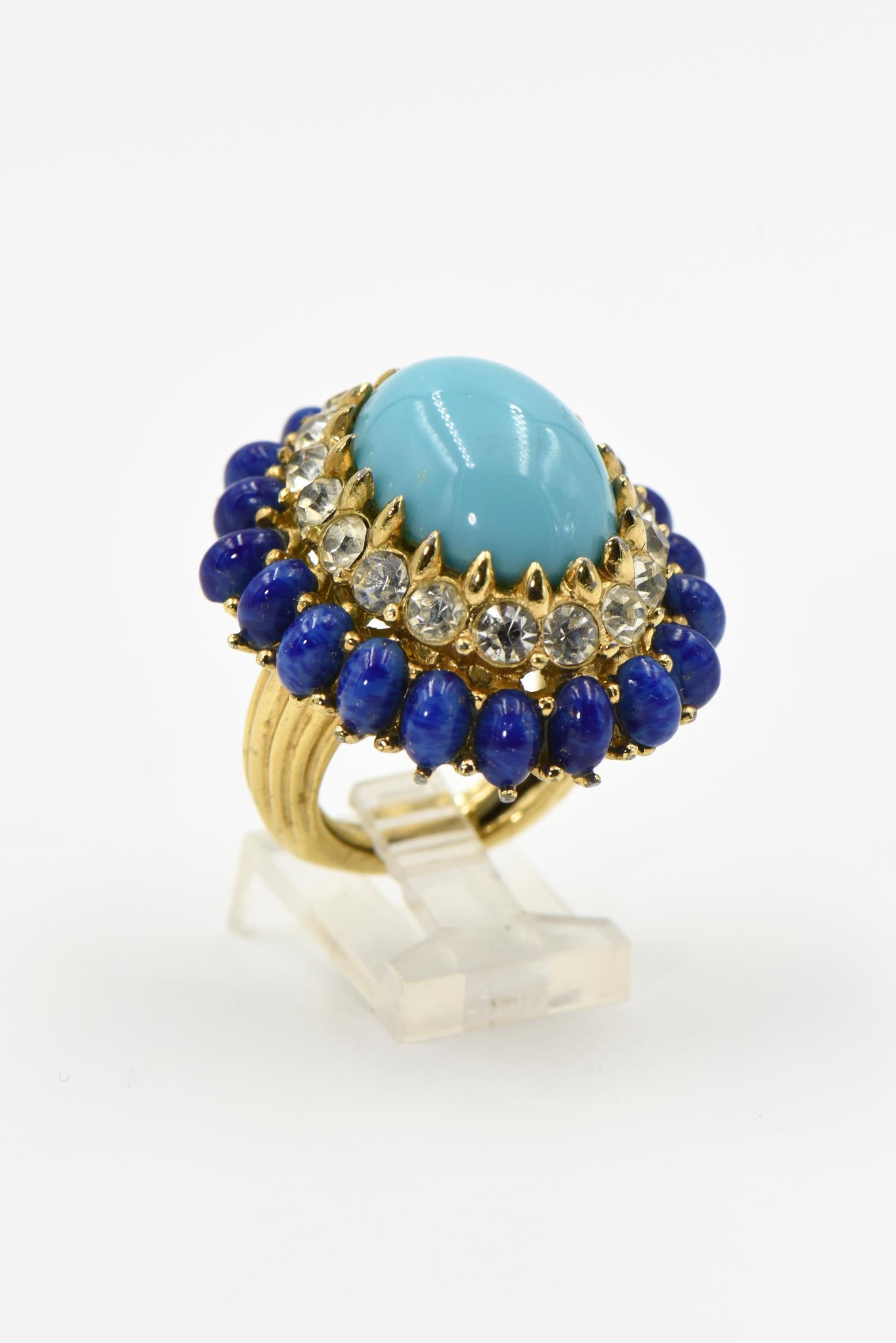 Impressive Mid 20th Century Jomaz dome shaped cocktail ring featuring simulated turquoise cabochon set amongst a faux diamonds and lapis lazuli frame.  
US size 6.5
Signed Jomaz
Matching earrings from the same collector sold separately.