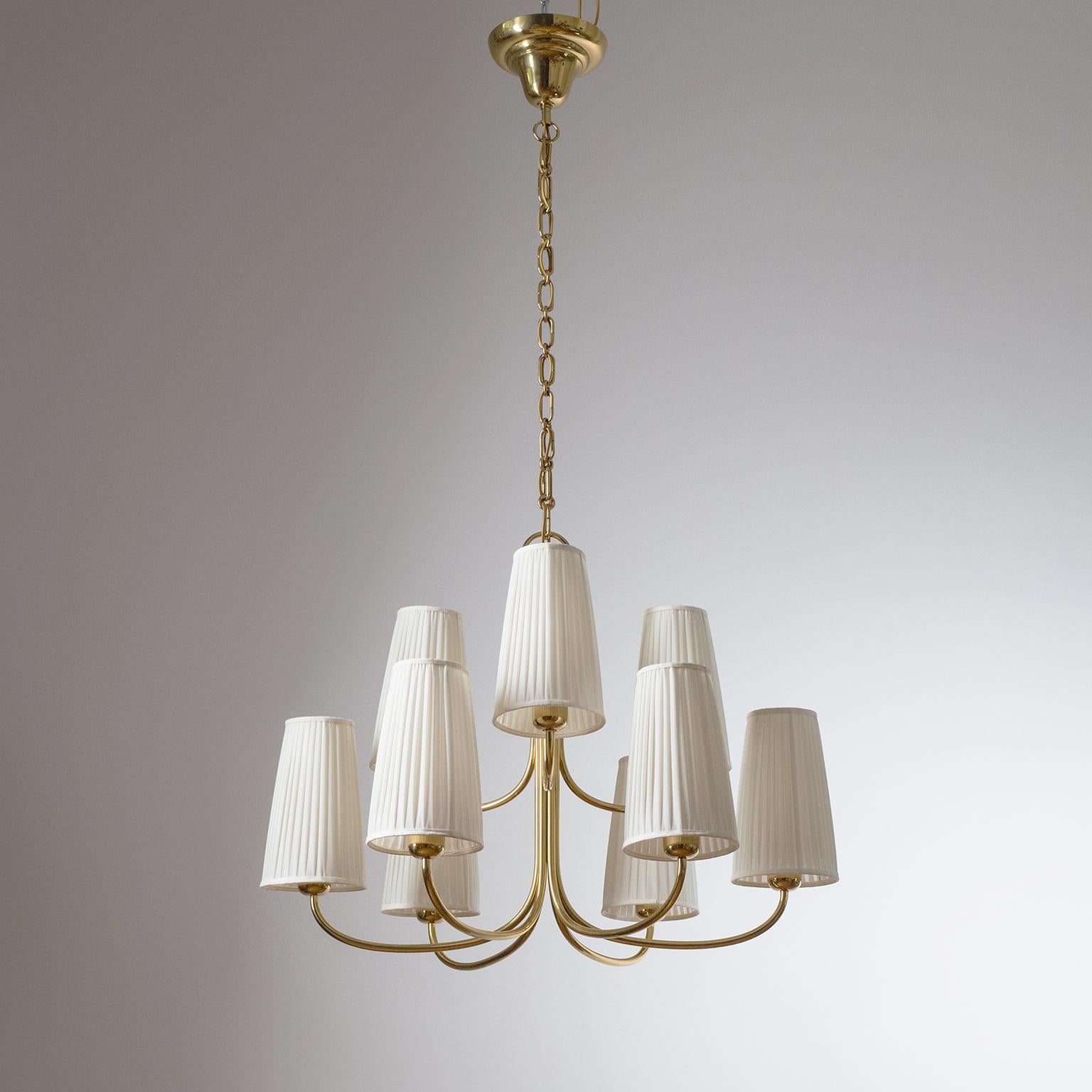 Rare large 9-arm brass chandelier by J.T. Kalmar produced in the 1940s. Beautiful 'cloud of light' most likely designed by Josef Frank, circa 1930. The Minimalist brass arms are arranged in two tiers, each holding a large original shade with new