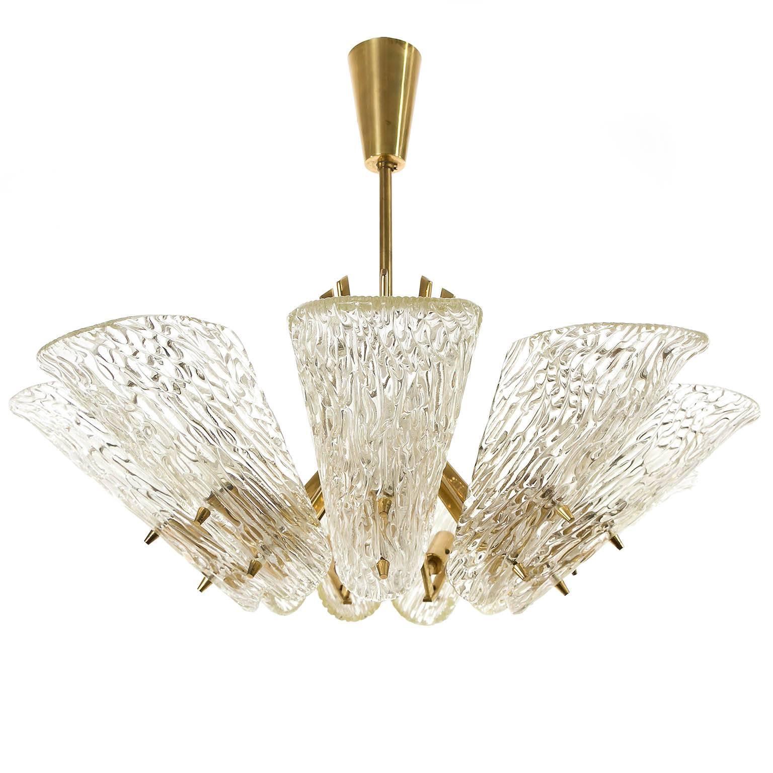 A glass and brass chandelier by J.T. Kalmar, Vienna, Austria, manufactured in midcentury, circa 1960 (late 1950s or early 1960s).
The light has nine arms with sockets for small Edison screw base E14 bulbs or LEDs (max. 40W per bulb) which are