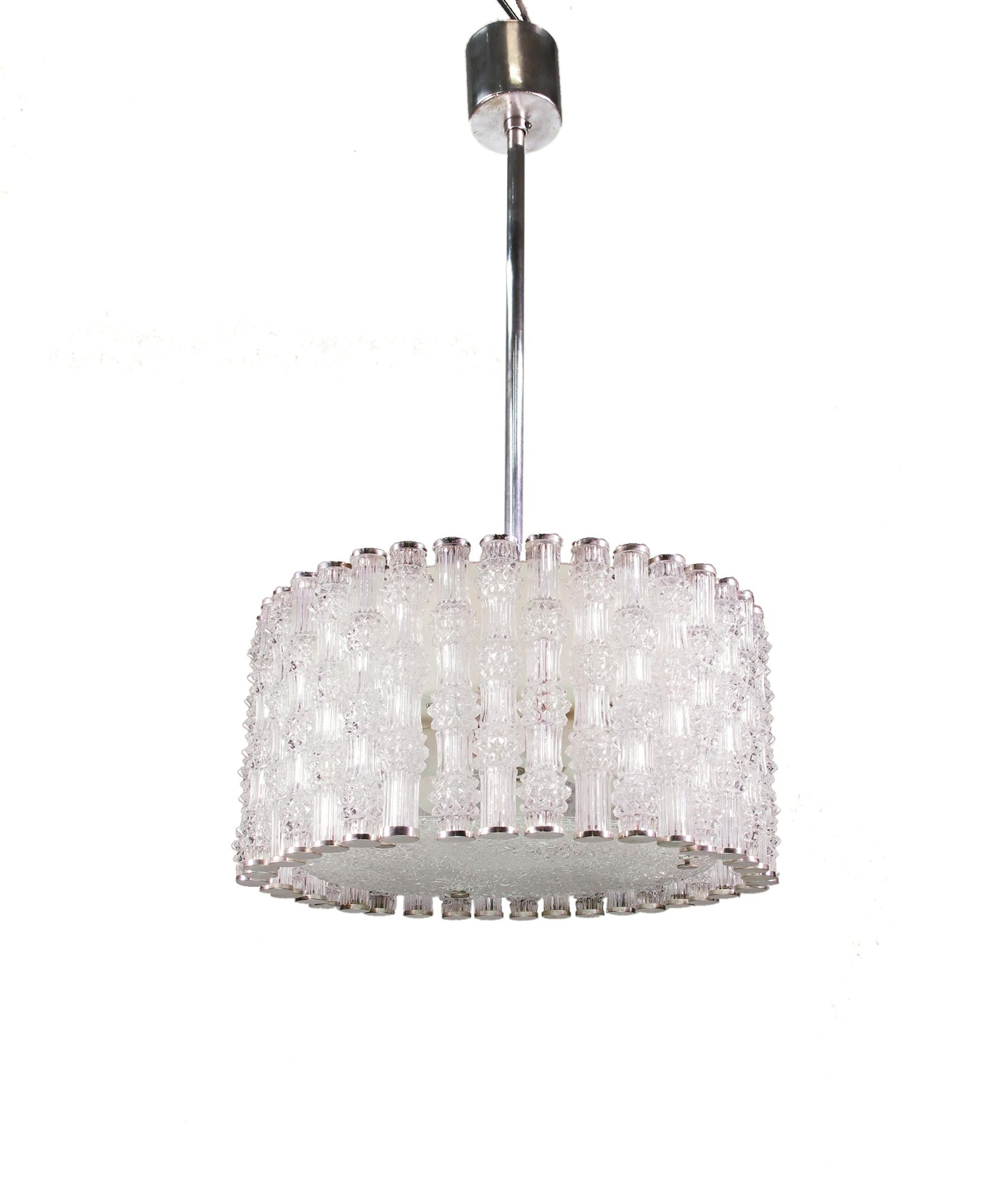 Elegant drum shaped chandelier with textured crystal glass tubes on a chromed frame designed by J.T. Kalmar in Vienna. Chandelier illuminates beautifully and offers a lot of light. Excellent vintage condition. Gem from the time. With this light you