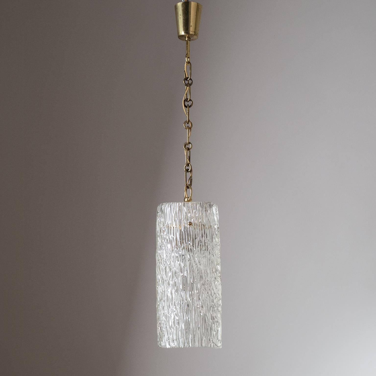 Large textured glass and brass pendant by J.T. Kalmar, circa 1950. Made from a single sheet of textured glass which is 'curled' into a large, slightly organic, cylinder. One original brass E27 socket with new wiring. Height without the chain is